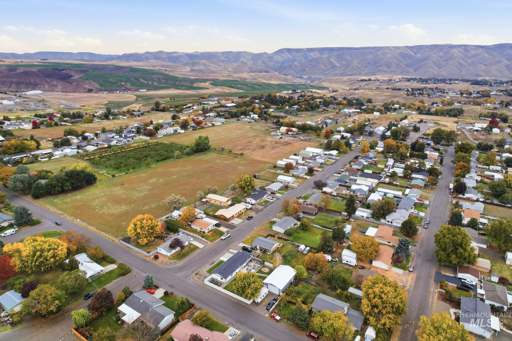 Aerial view of property's location with mountains and nearby suburban area