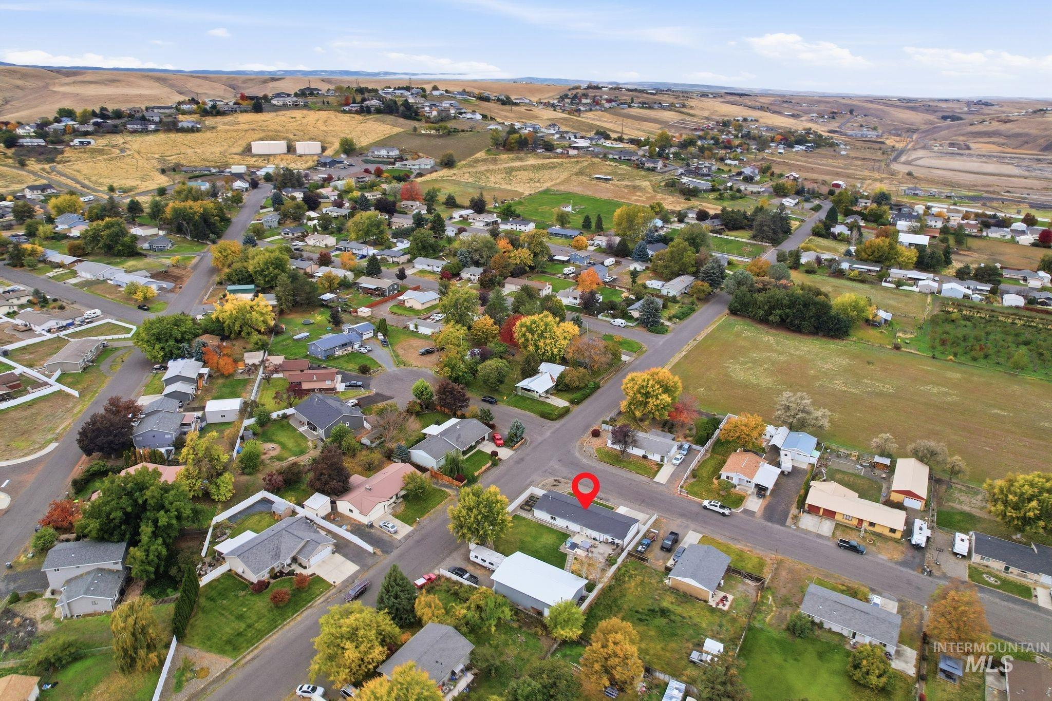 Aerial view of property's location featuring nearby suburban area