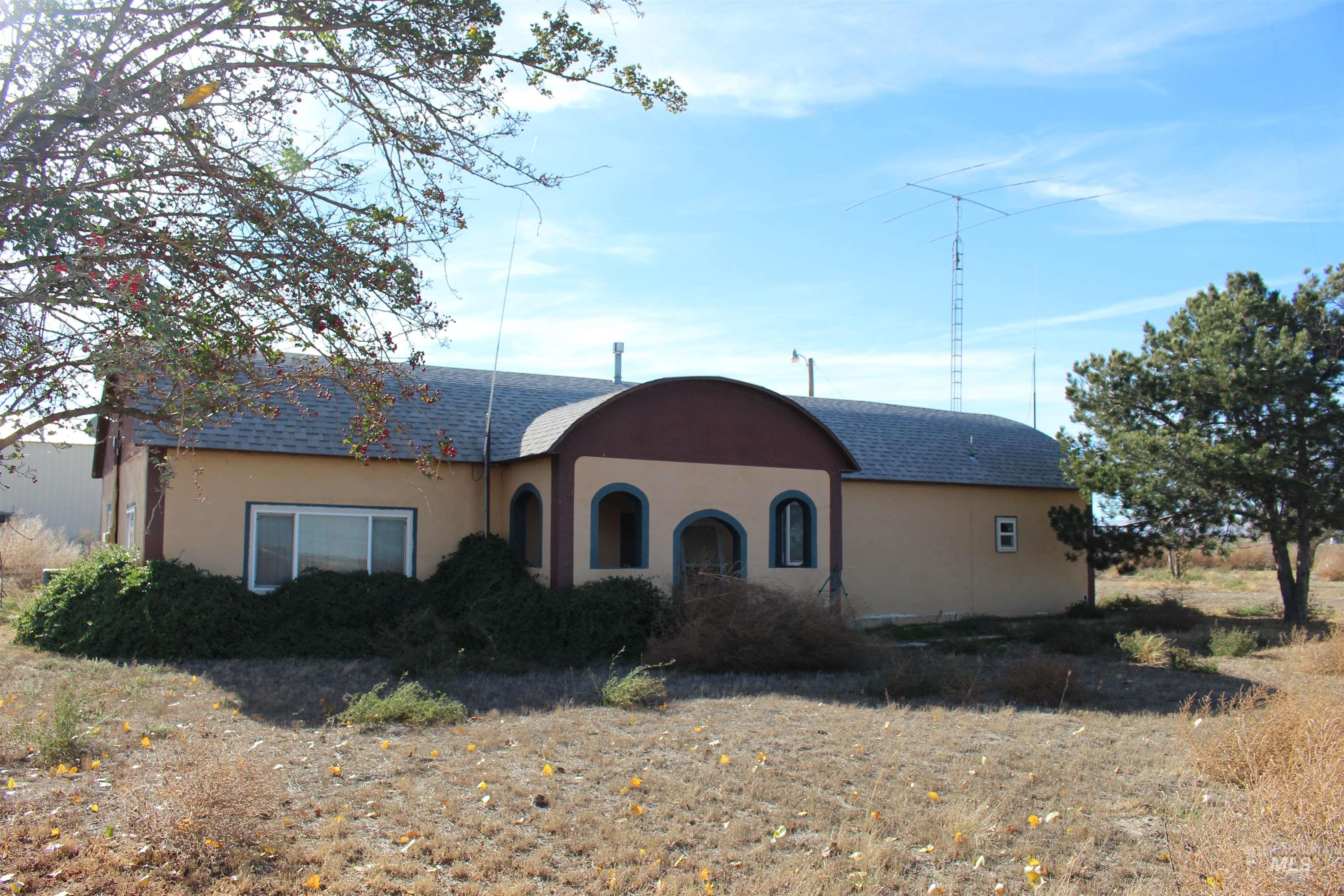 View of front facade featuring stucco siding and roof with shingles