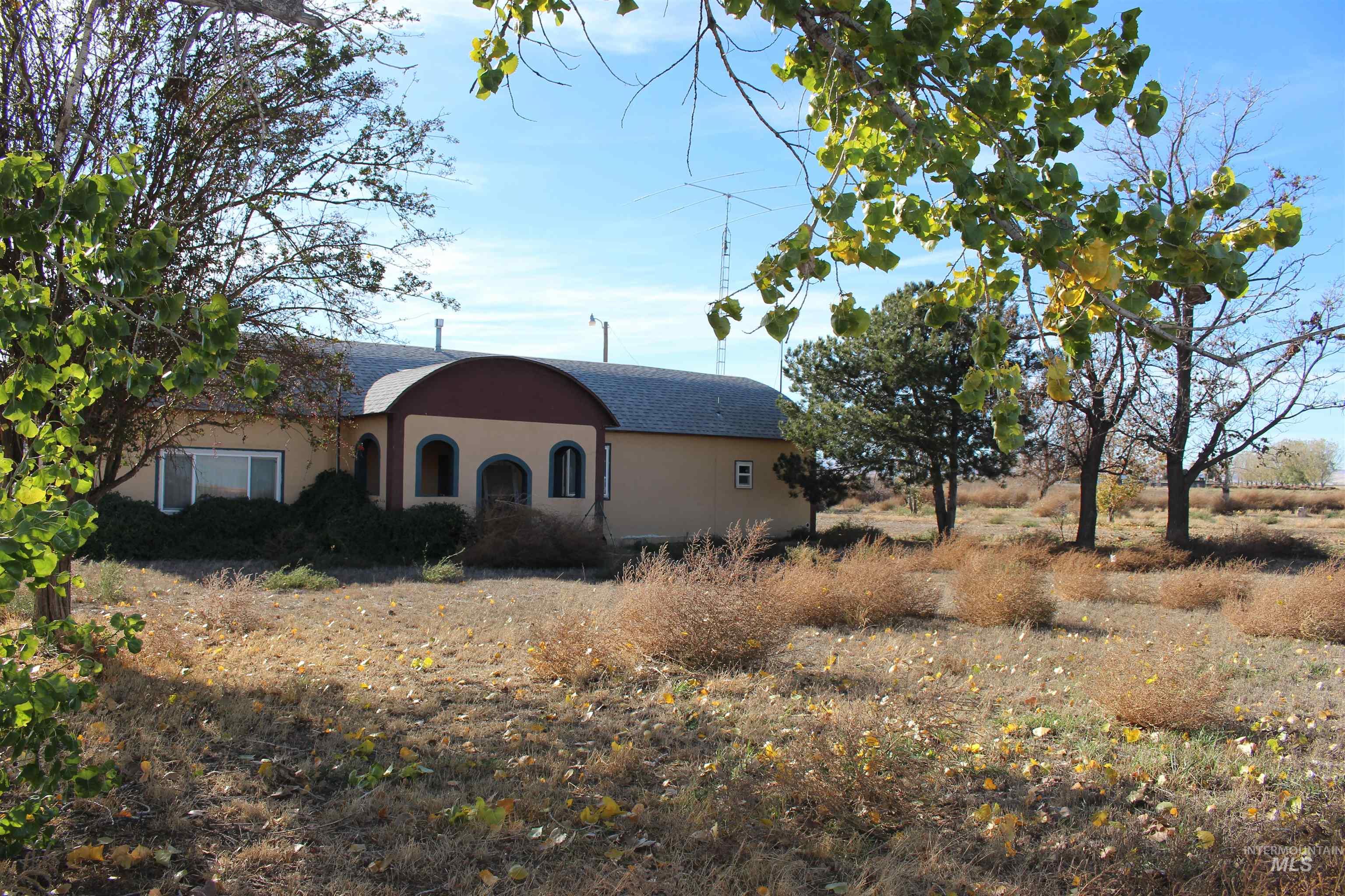 View of front facade with stucco siding and roof with shingles
