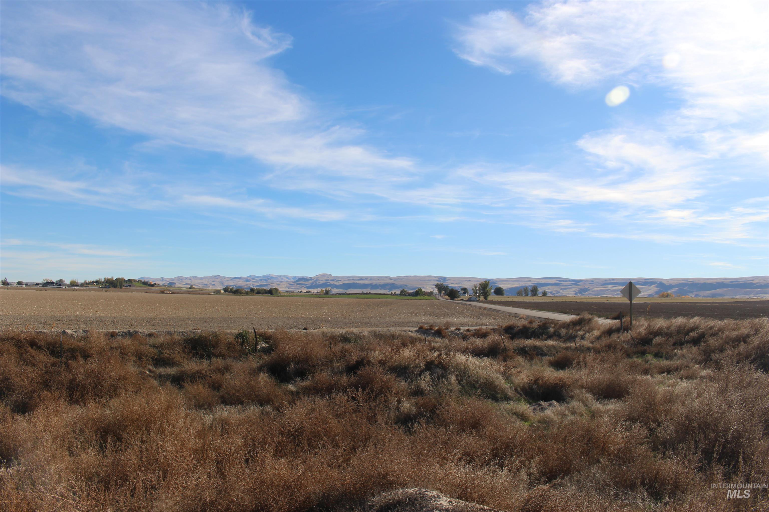 View of mountain backdrop featuring rural landscape