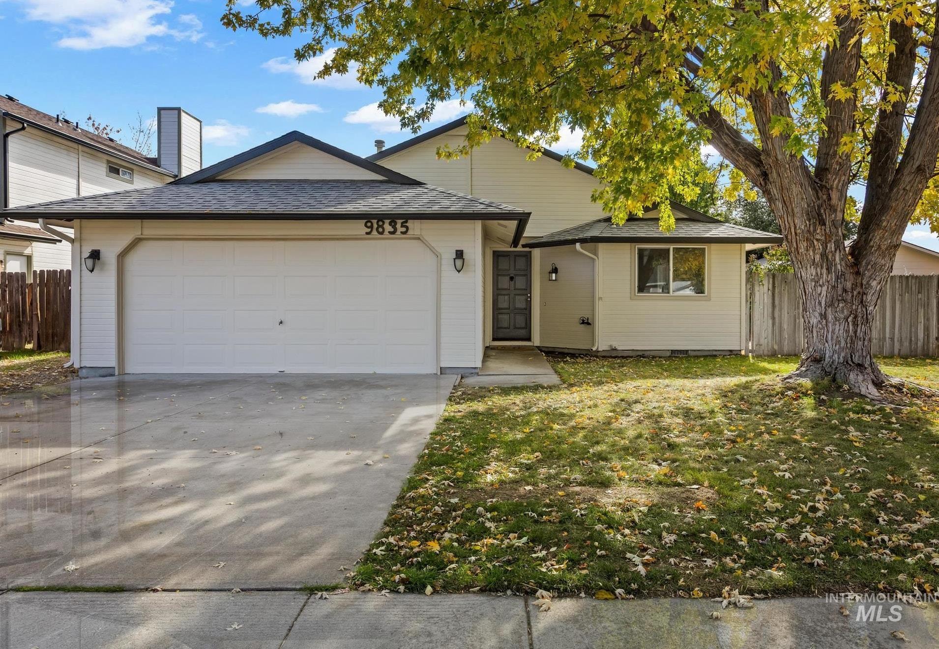 Ranch-style home featuring a shingled roof, driveway, and an attached garage