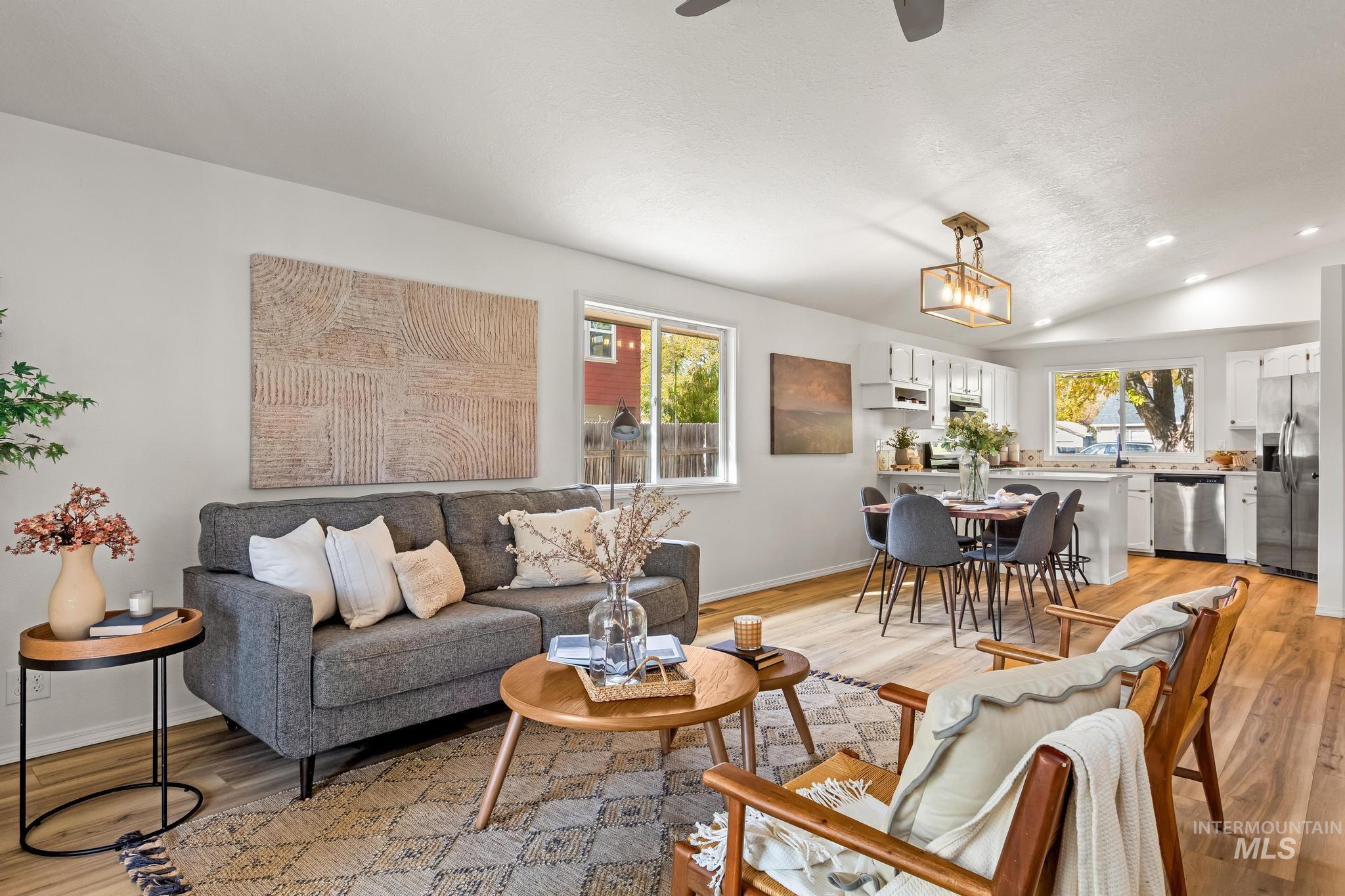 Living area with light wood-style floors, lofted ceiling, recessed lighting, and ceiling fan