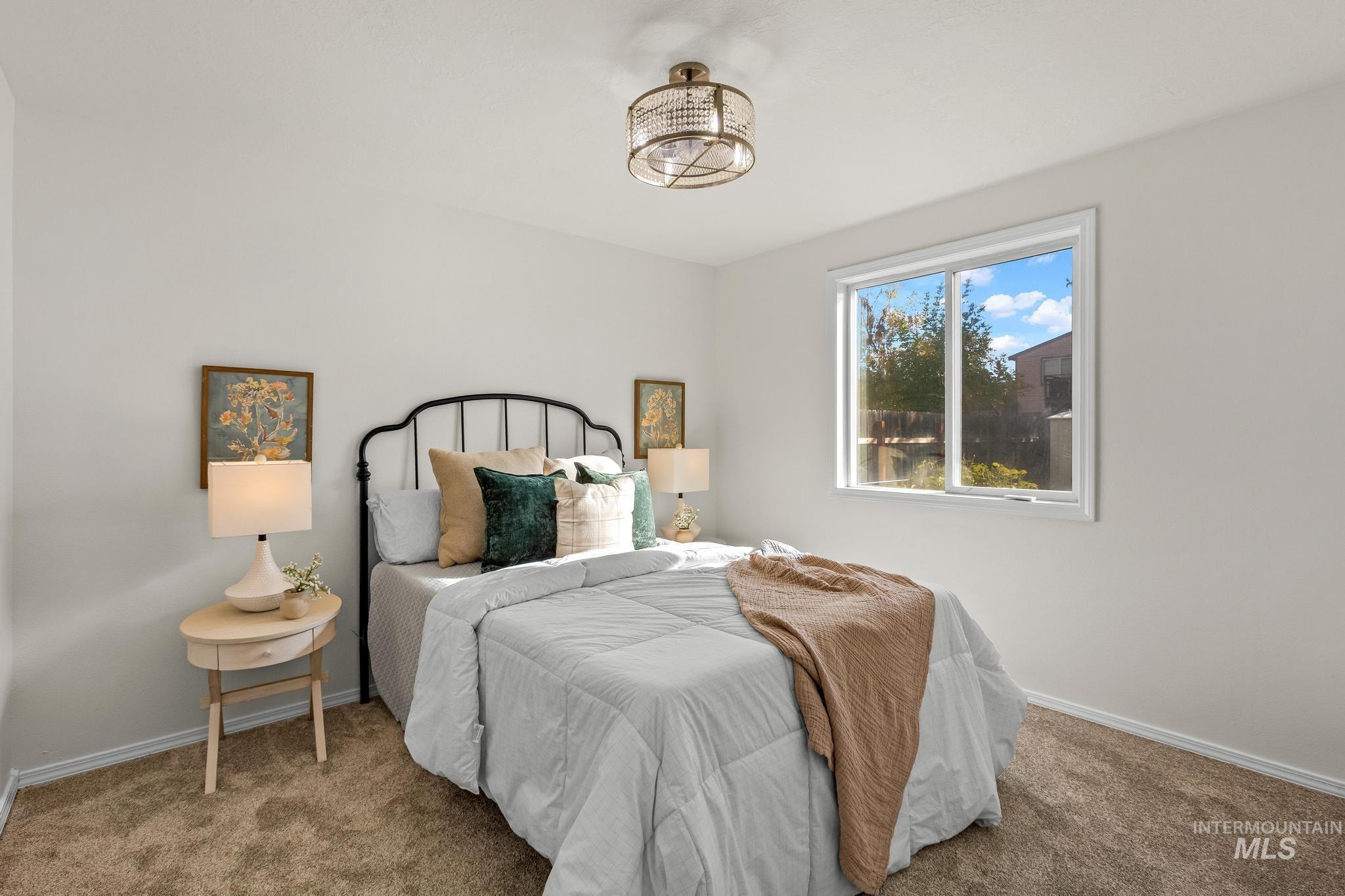 Bedroom with baseboards and carpet floors