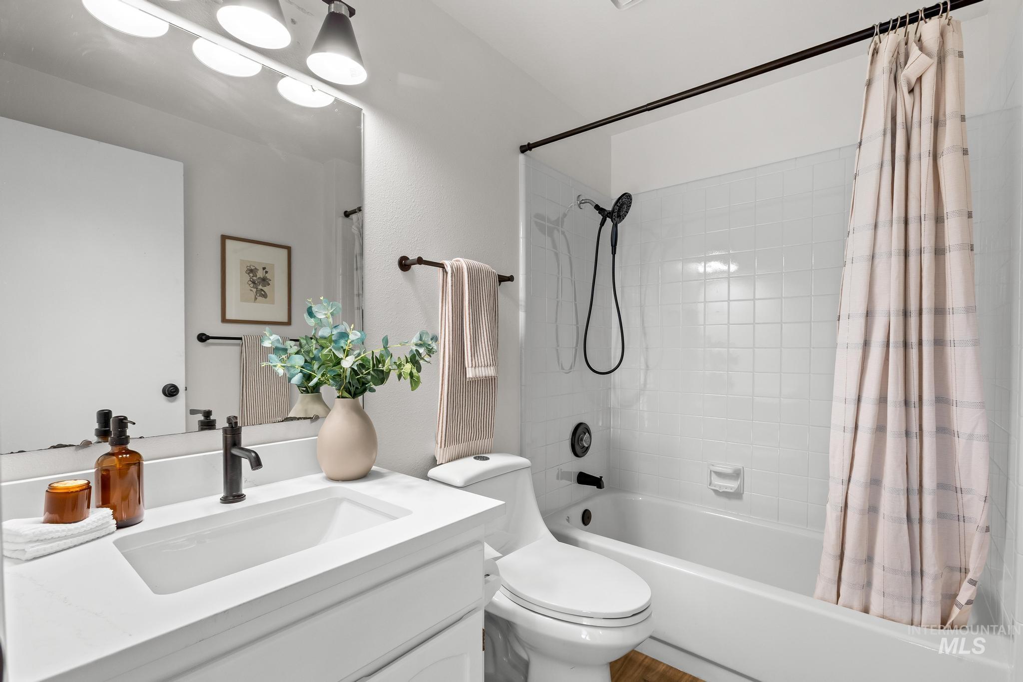 Full bathroom with shower / bath combination with curtain and vanity