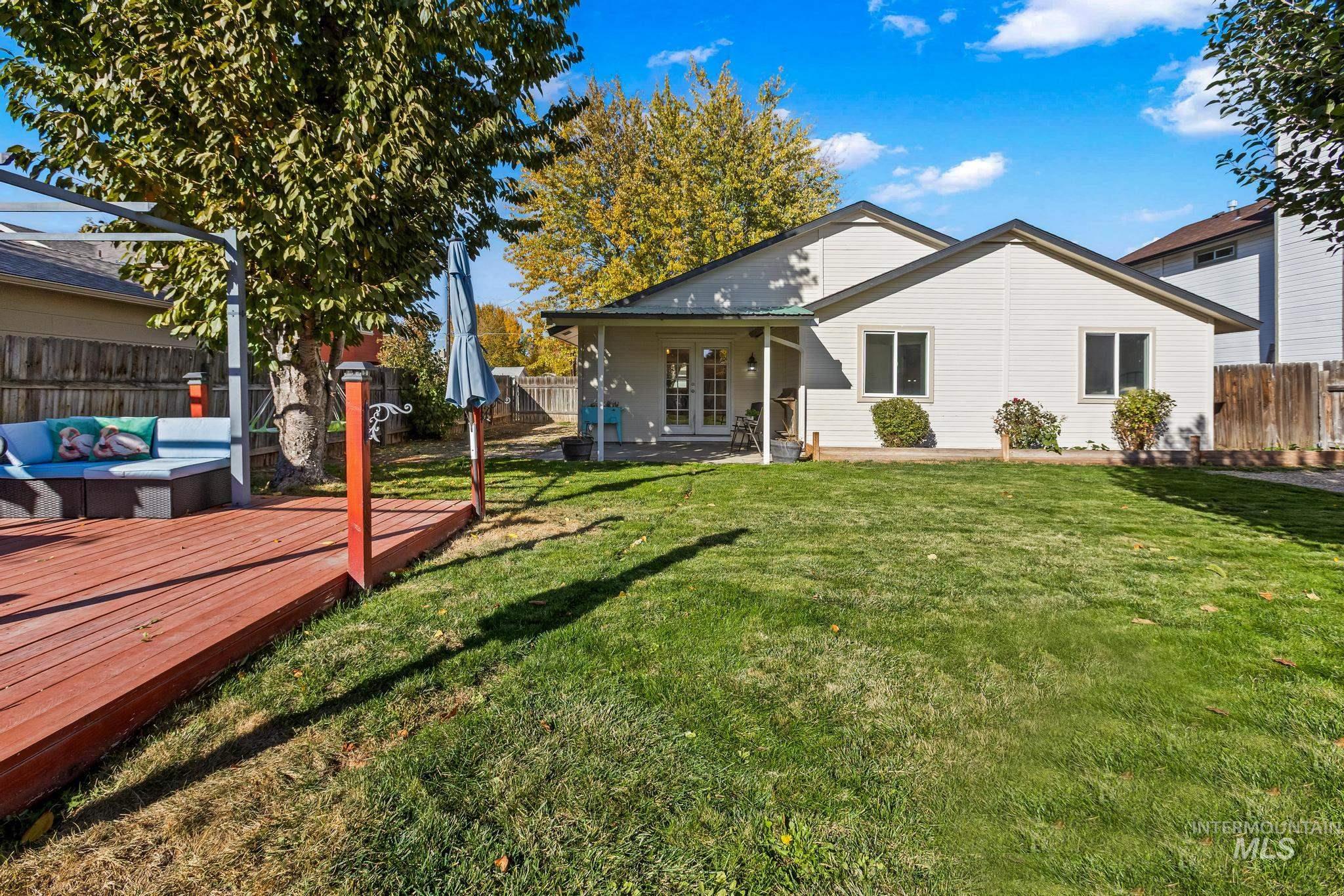 Back of property with a fenced backyard, a patio, an outdoor hangout area, french doors, and a deck