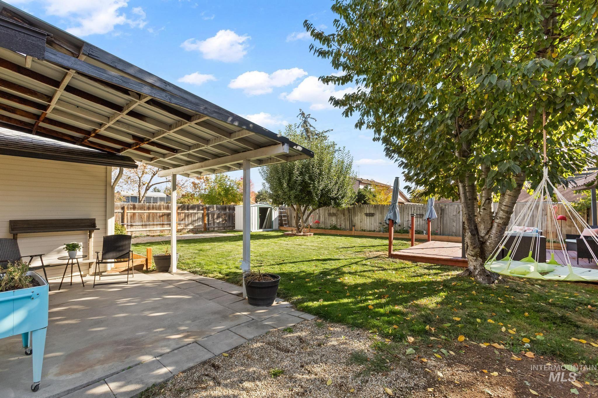 Fenced backyard with a patio and an outdoor structure