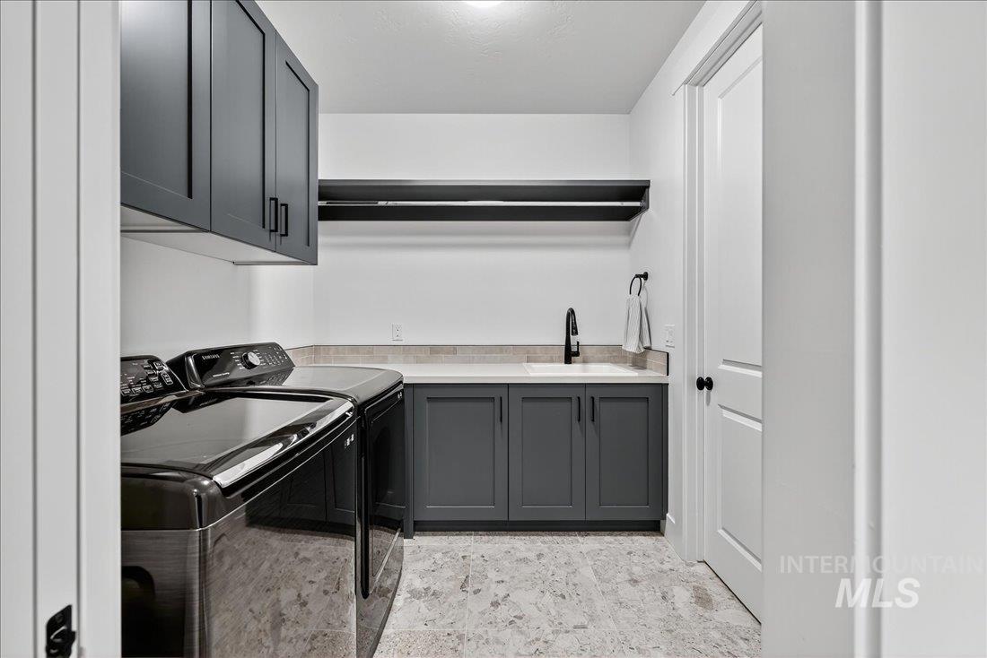 Laundry area with cabinet space and washing machine and dryer