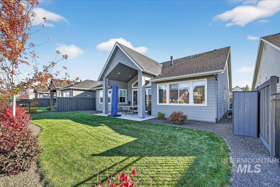 Back of property with a fenced backyard, a patio area, and roof with shingles