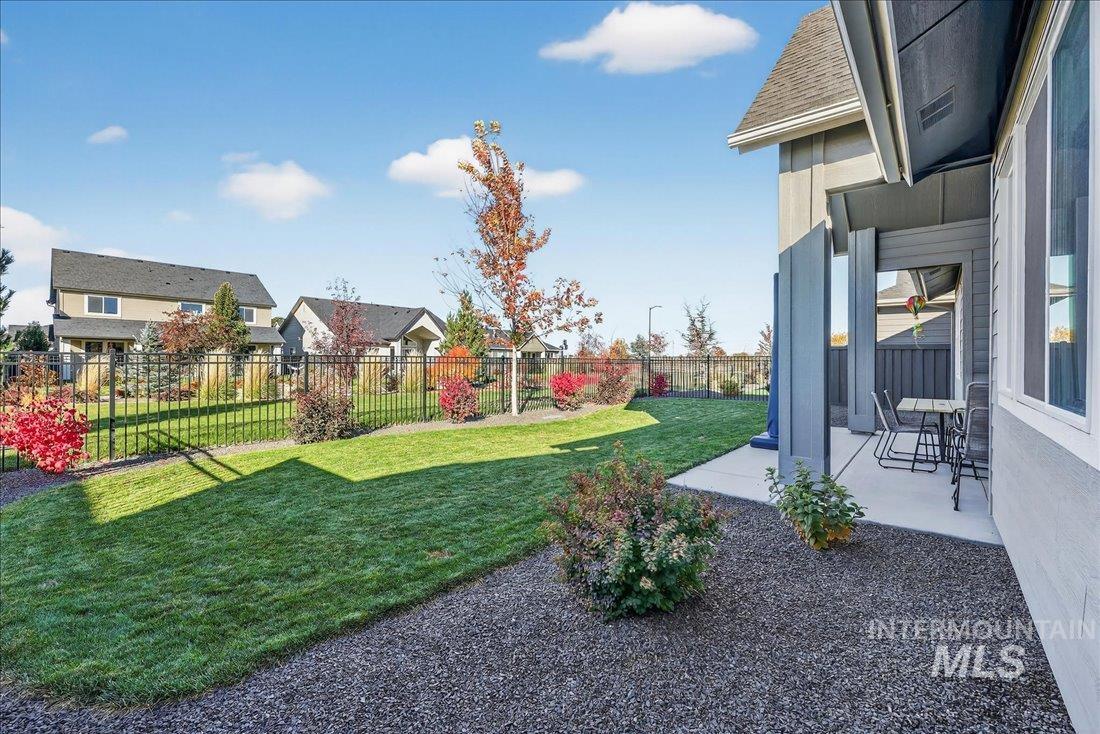 Fenced backyard with a residential view