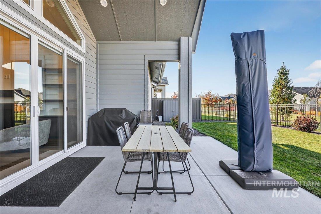 View of patio with outdoor dining area and area for grilling