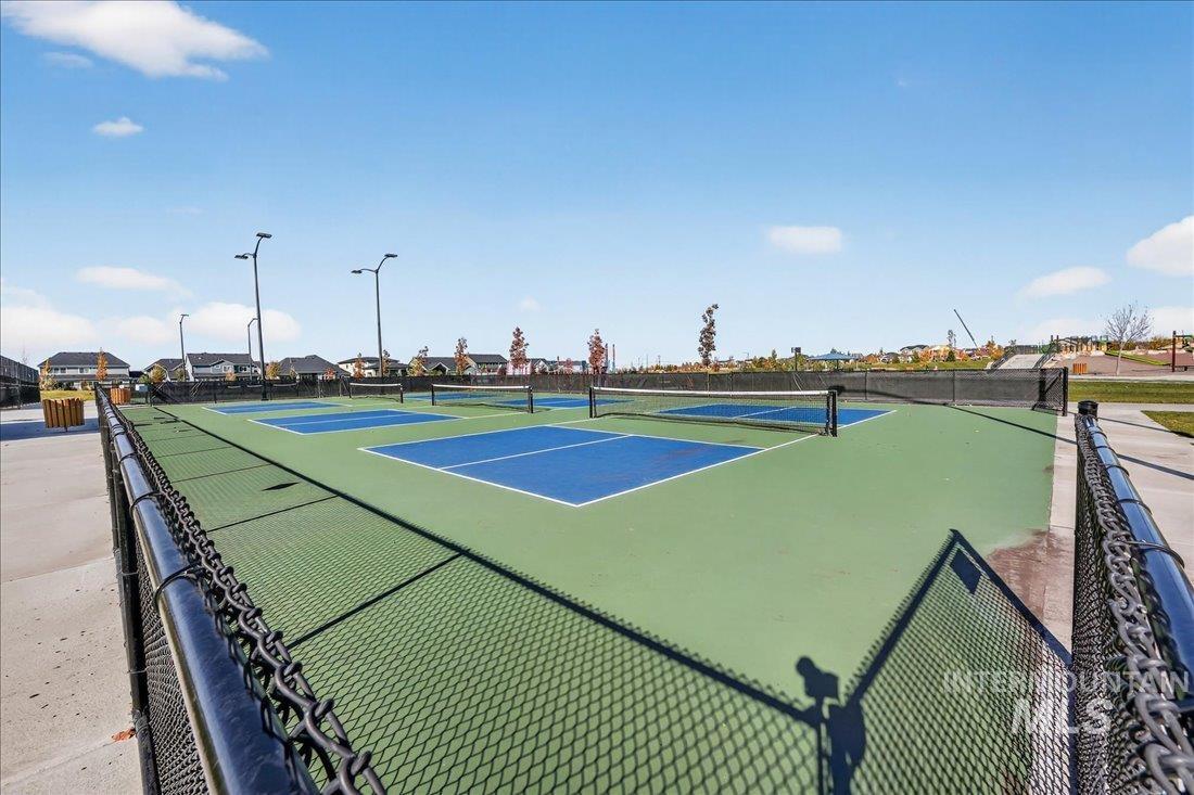 View of tennis court with community basketball court