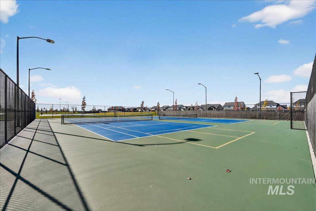 View of tennis court with community basketball court