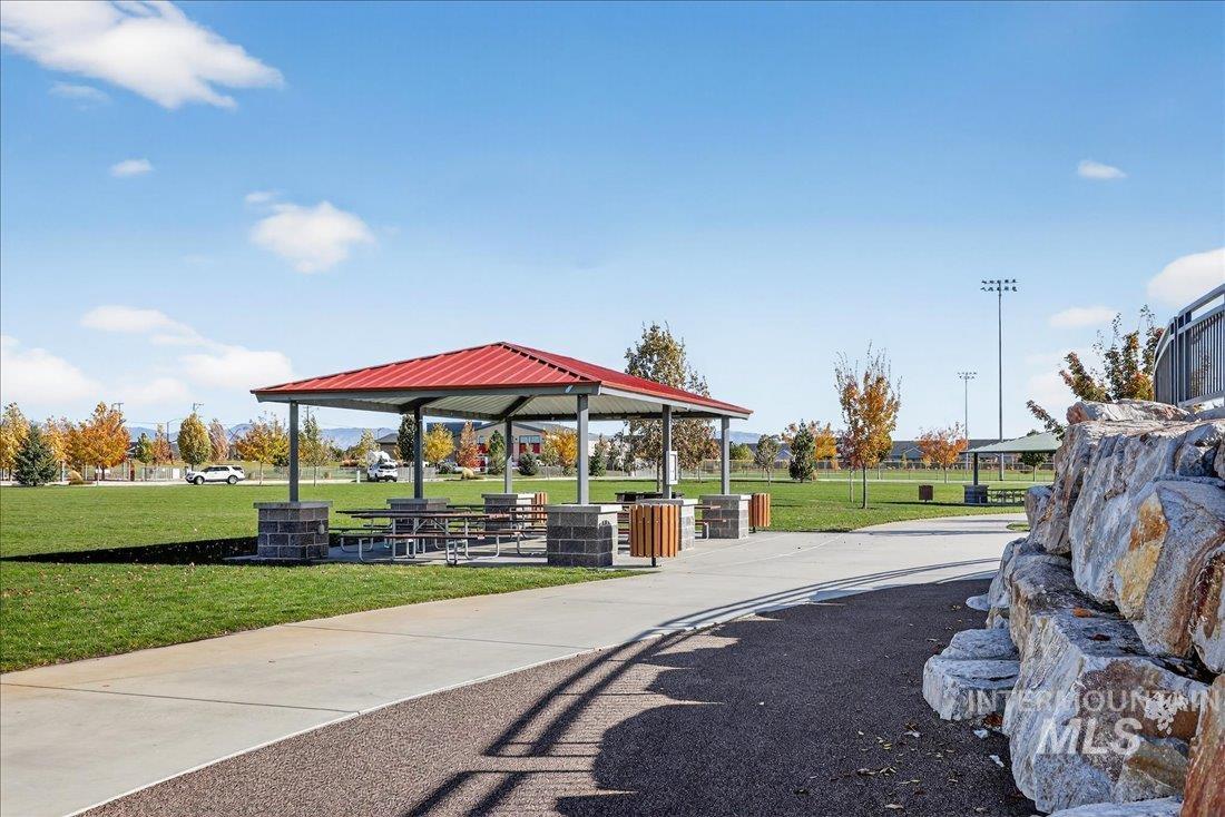 View of property's community with a yard and a patio