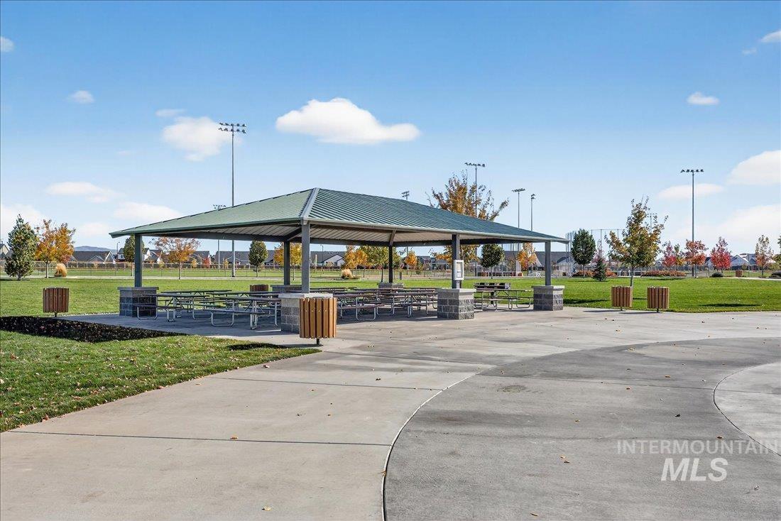 View of property's community with a lawn and a patio