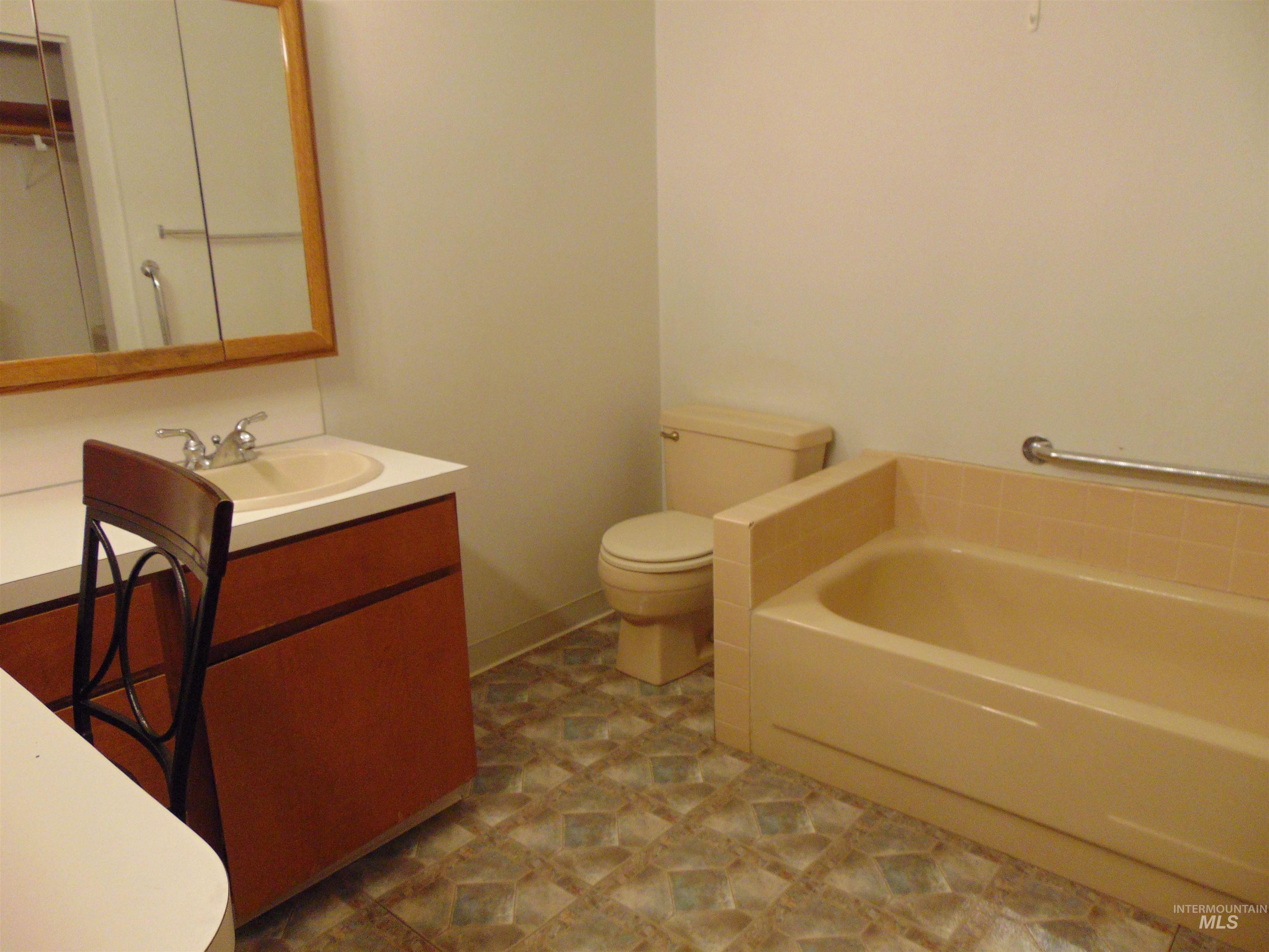 Bathroom featuring vanity and a garden tub