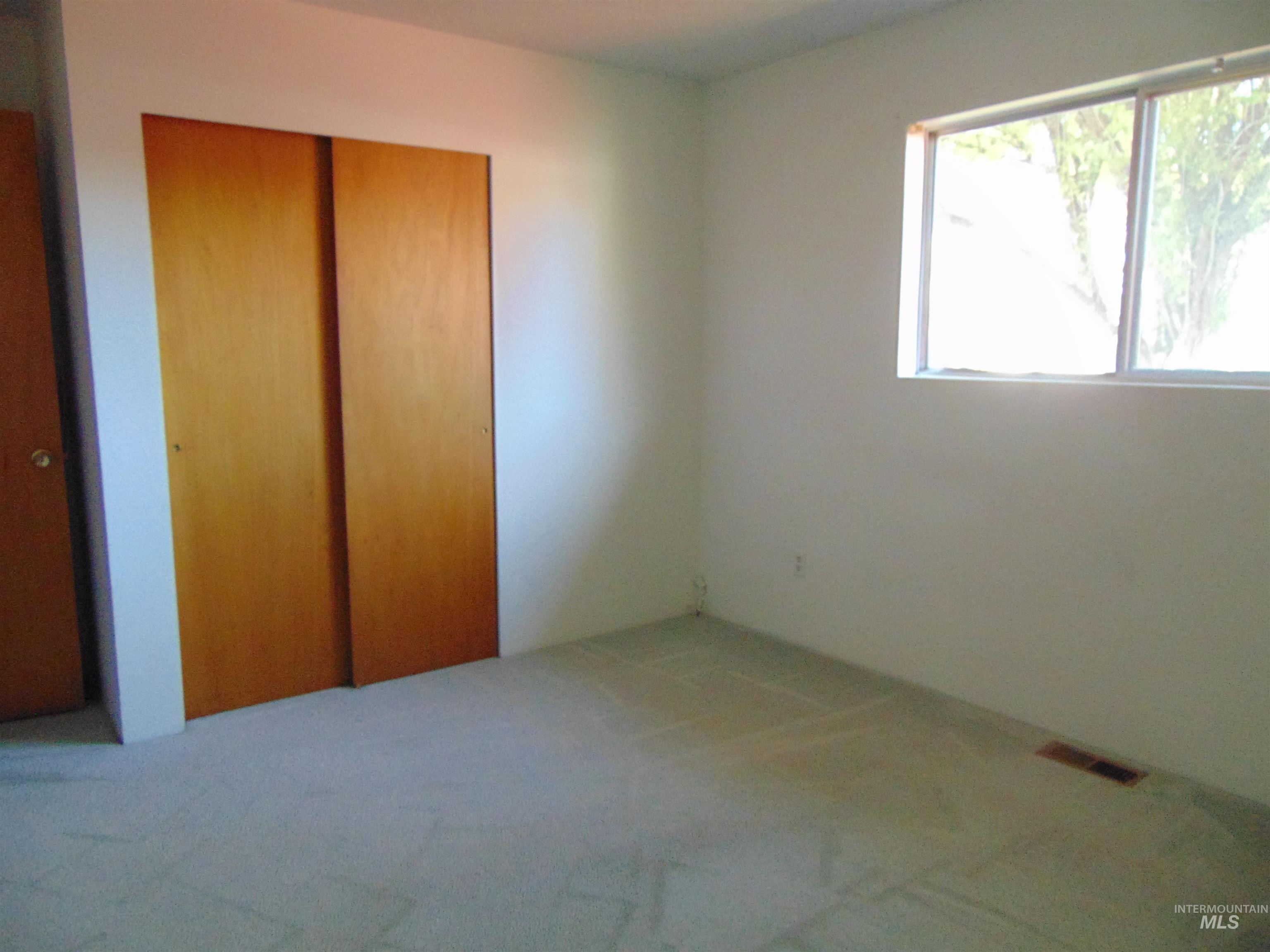 Unfurnished bedroom featuring a closet and carpet floors