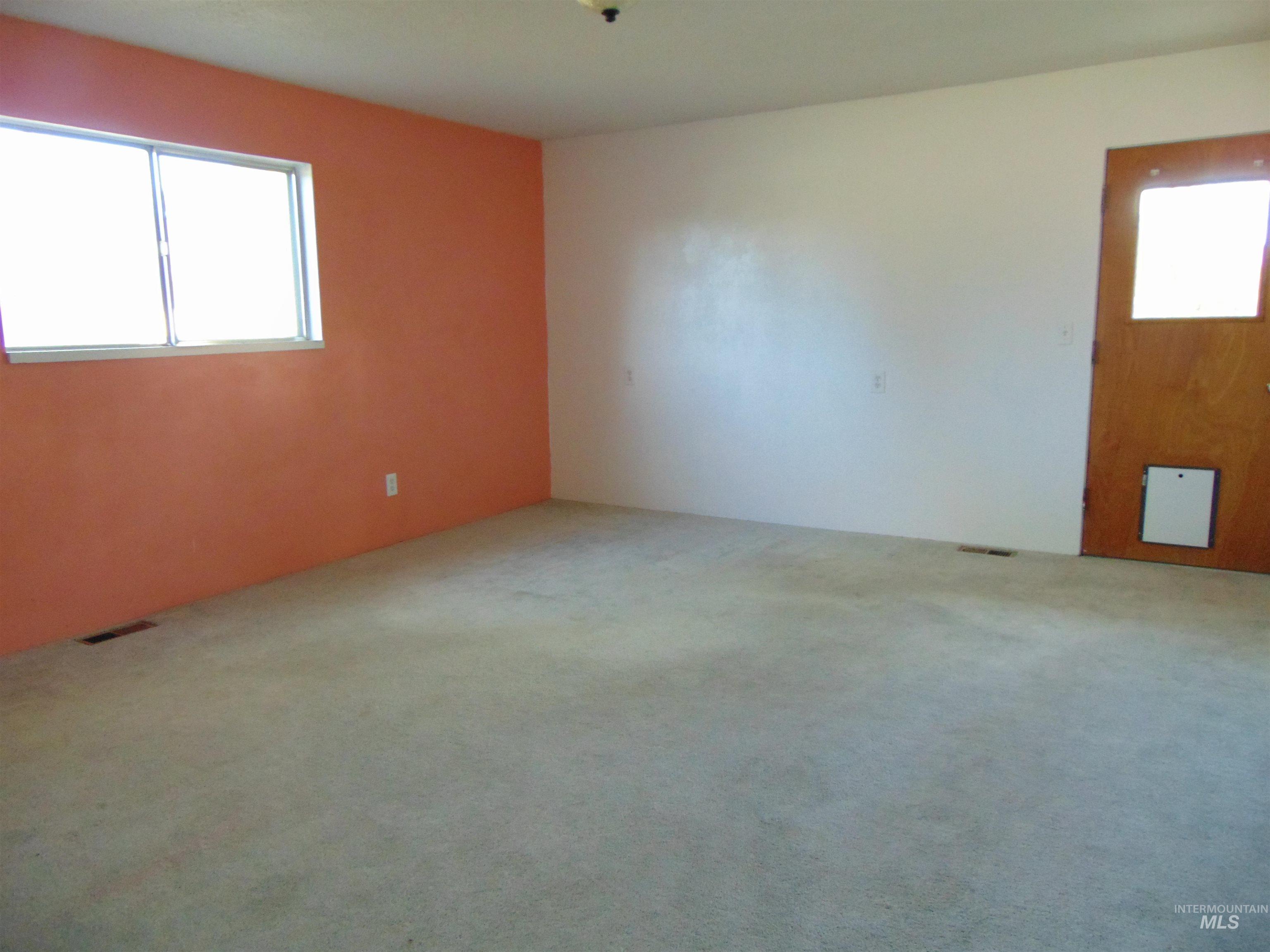 Spare room featuring plenty of natural light and carpet