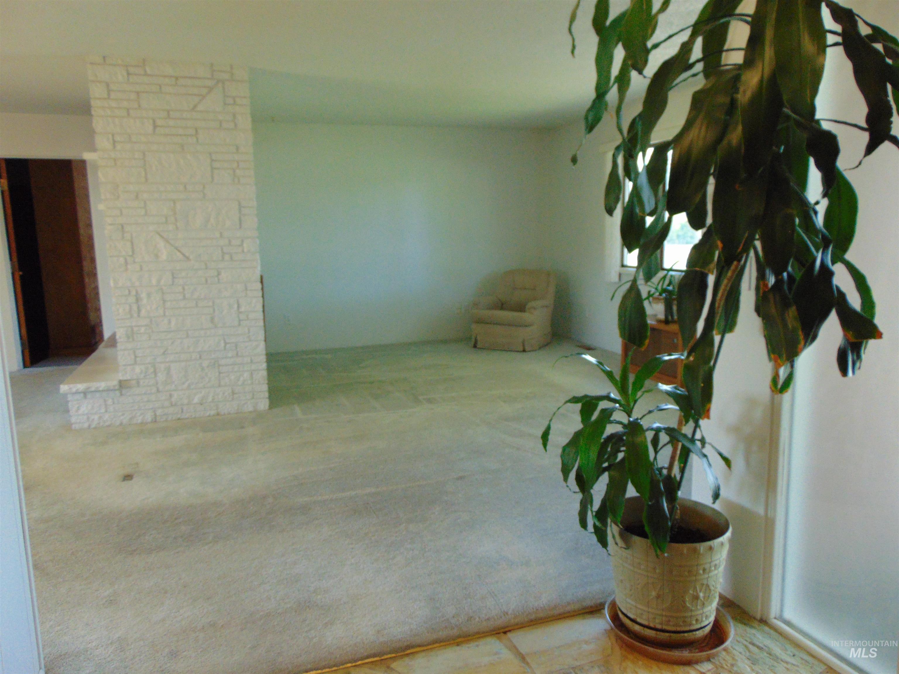 Carpeted spare room with decorative columns