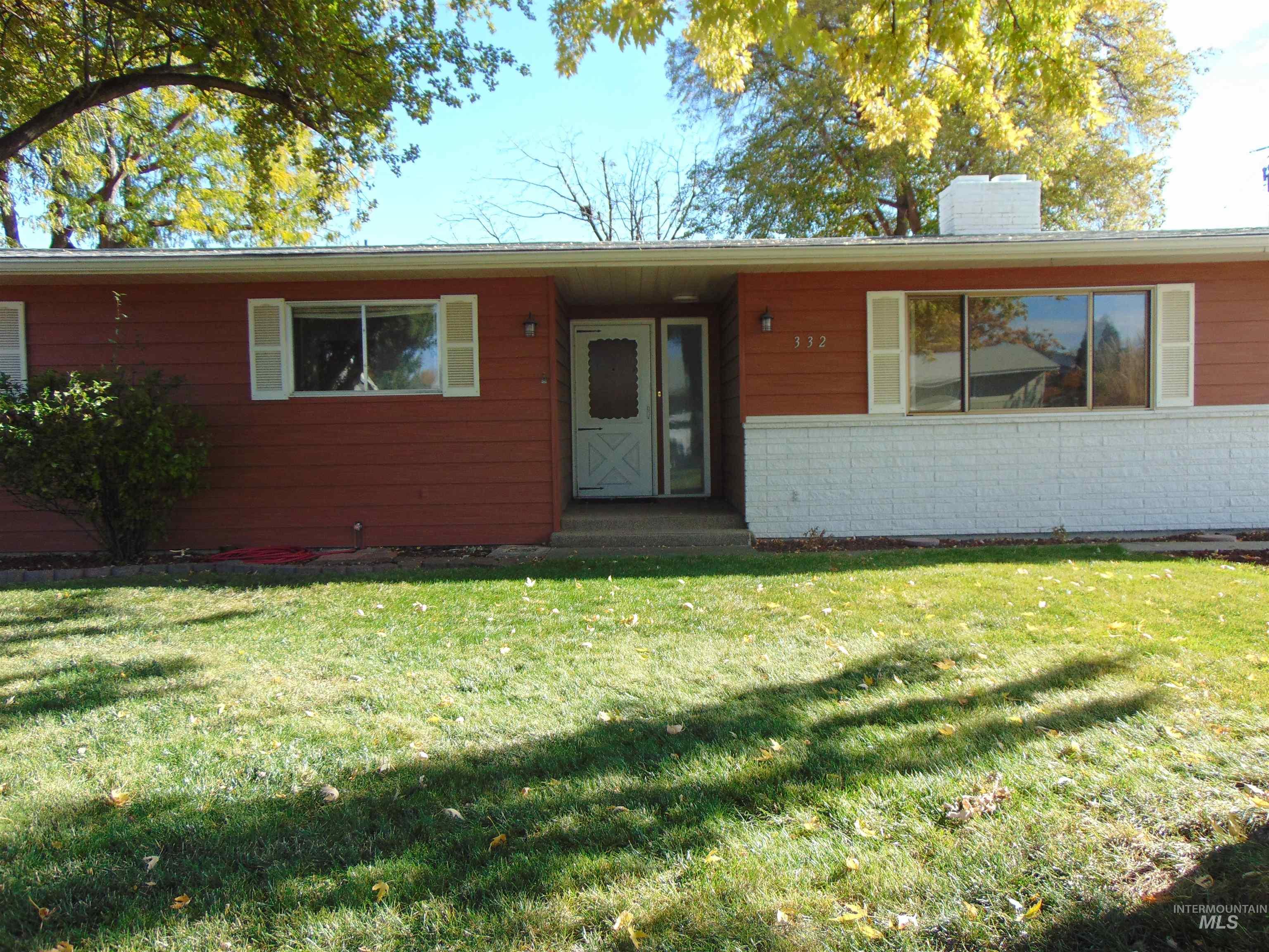 View of front of home featuring a front yard and a chimney