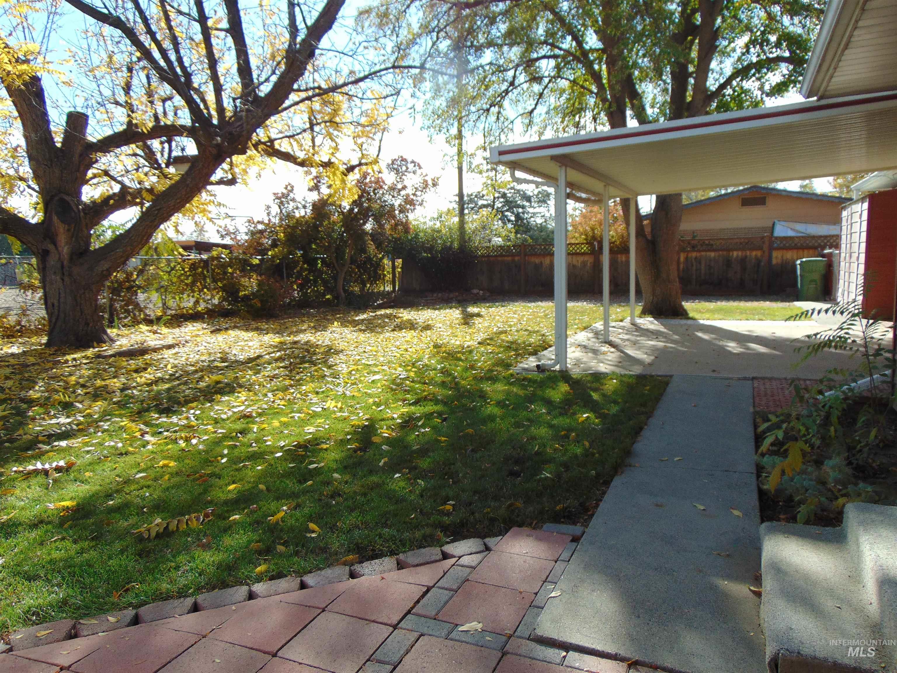 Fenced backyard with a patio
