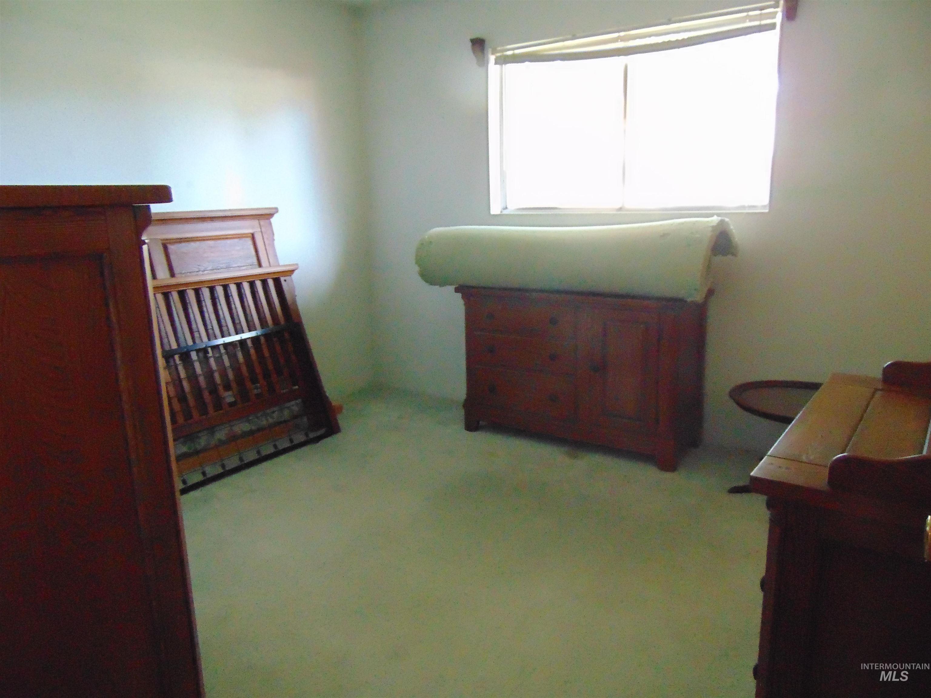 Bedroom featuring light carpet