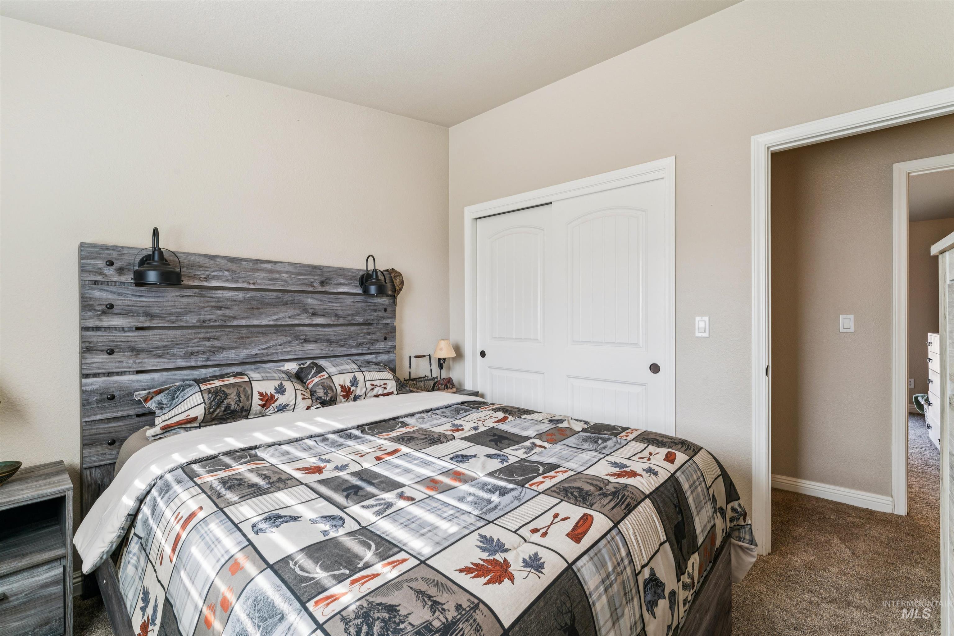Bedroom featuring carpet flooring and a closet