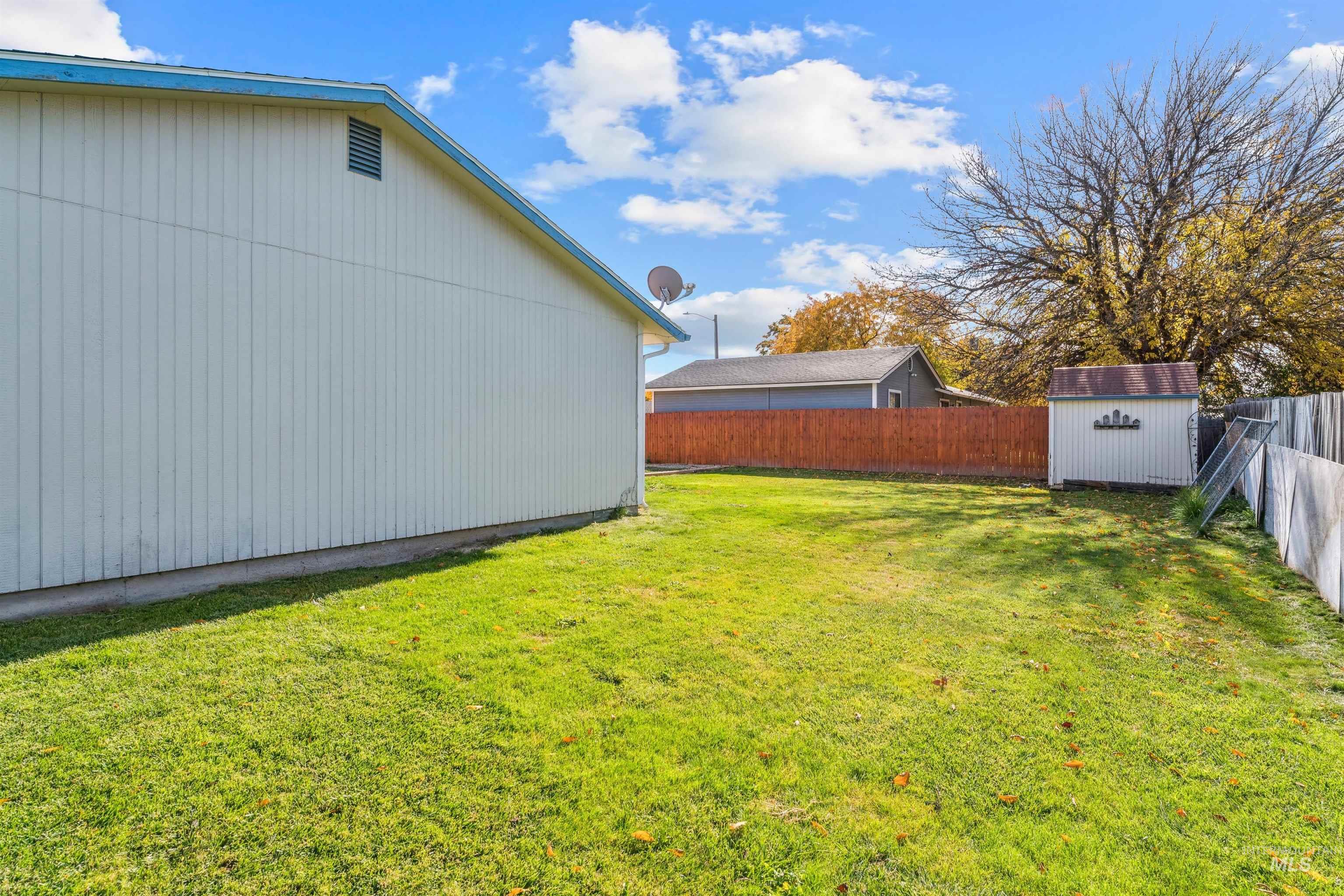 Fenced backyard with a storage unit