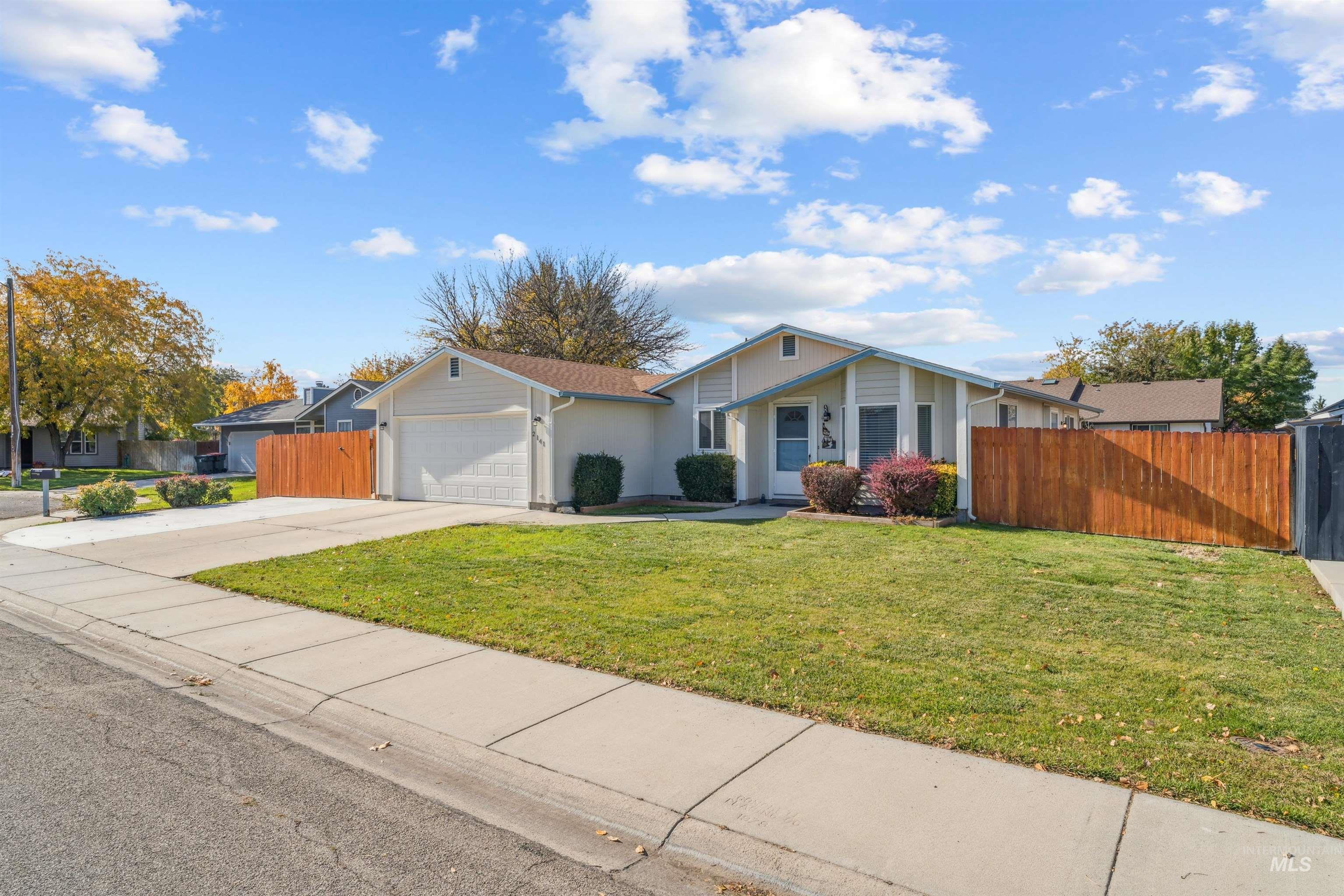 View of front of home featuring concrete driveway and an attached garage