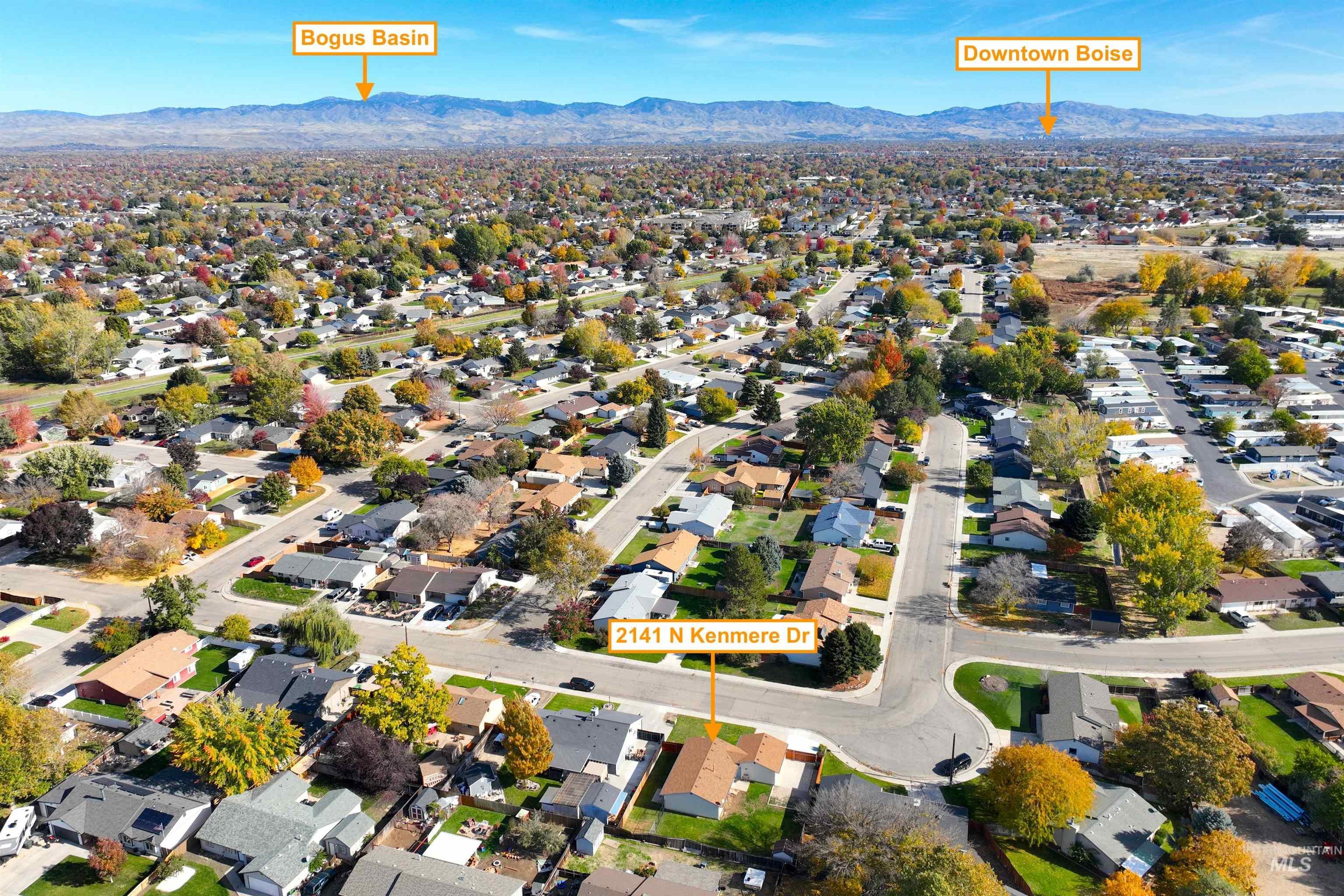 Aerial view of property's location featuring nearby suburban area and mountains