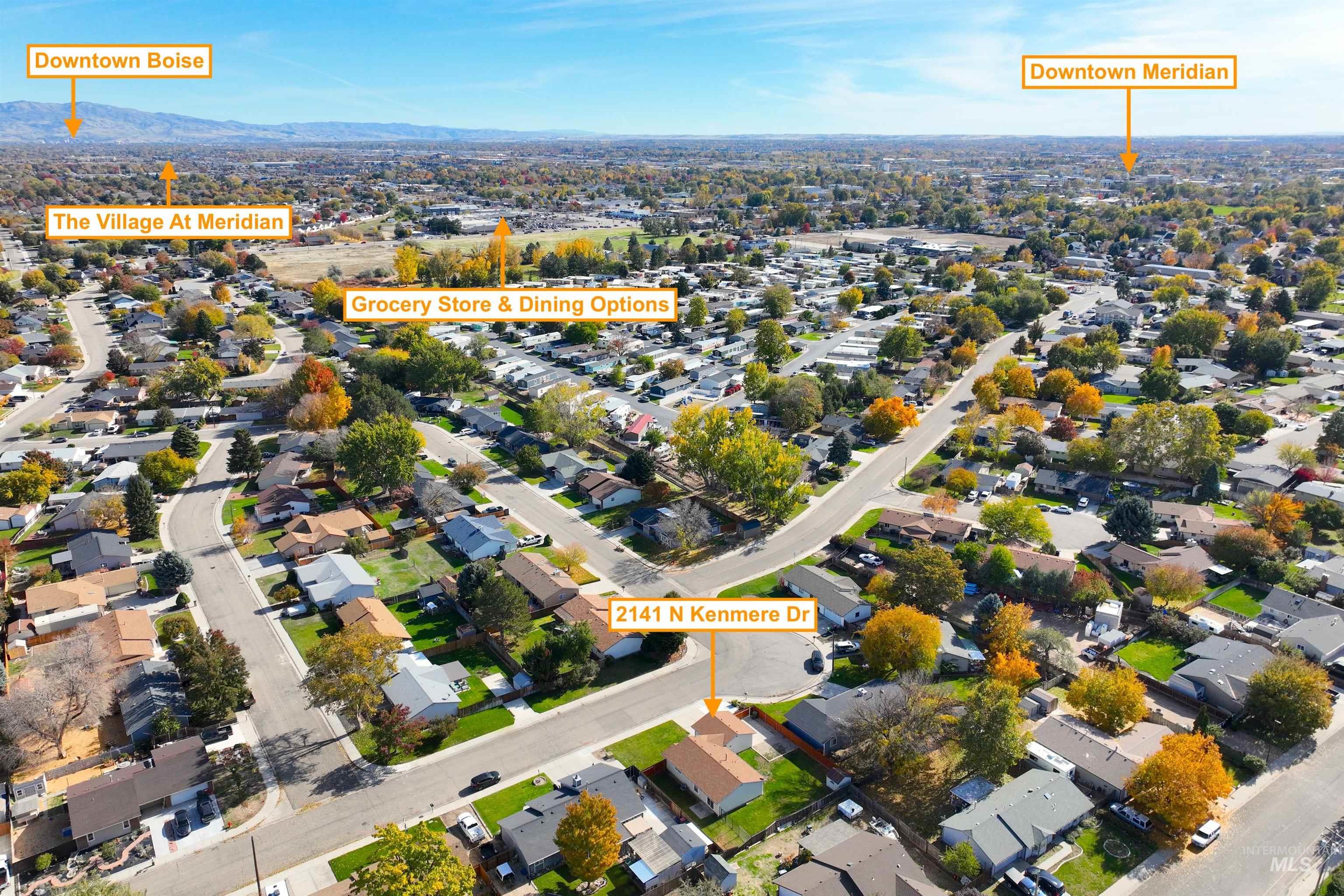 Aerial overview of property's location featuring nearby suburban area and a mountain backdrop