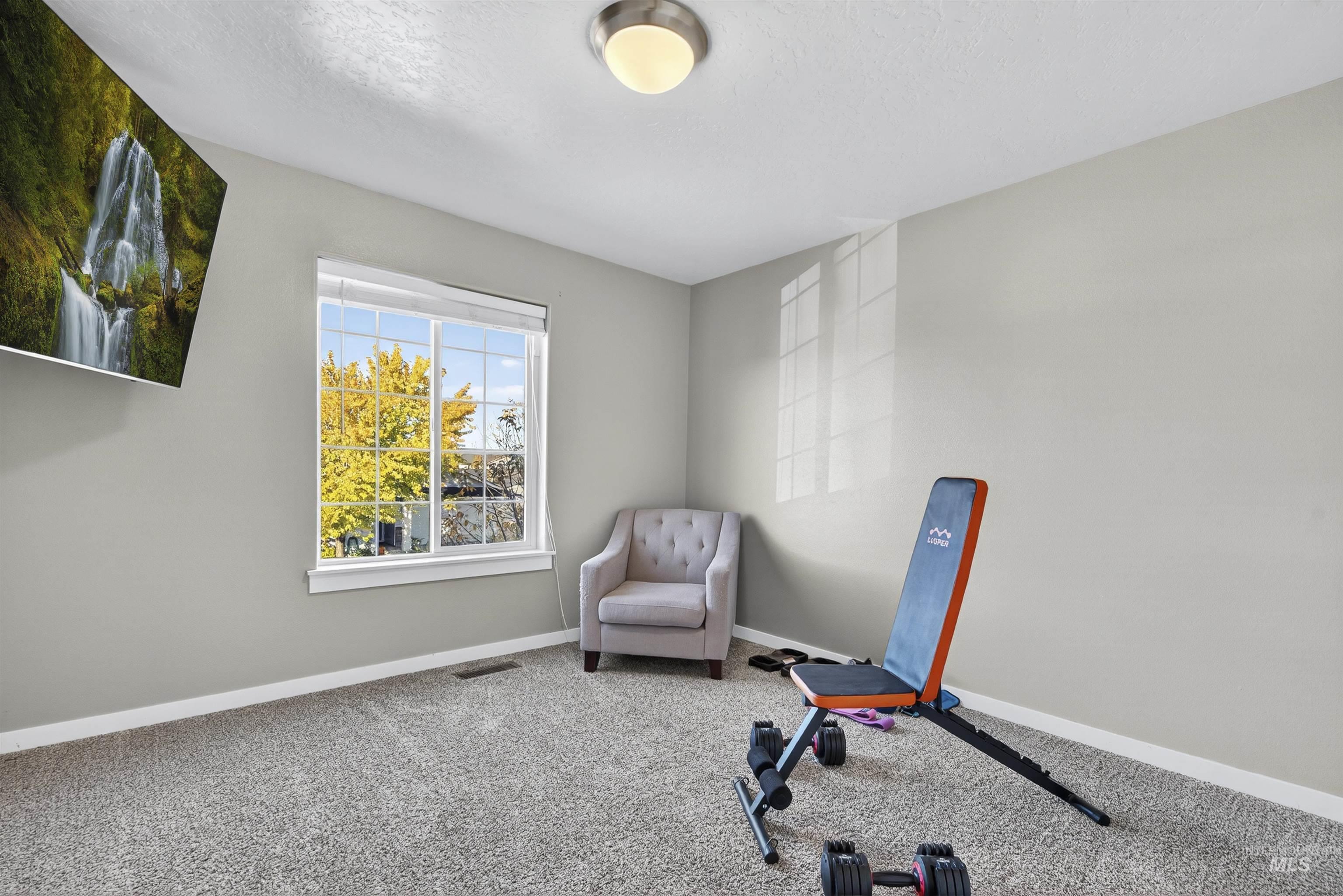 Workout area with carpet and a textured ceiling