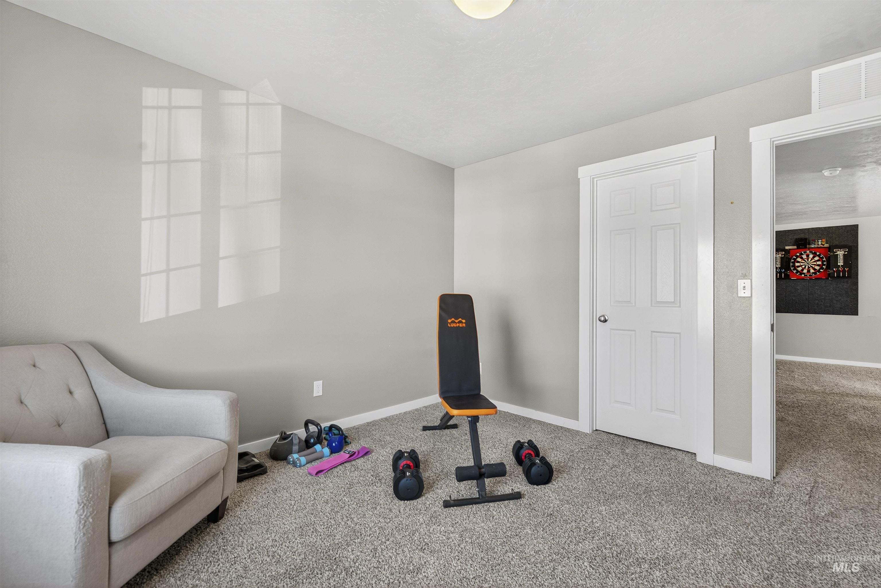 Workout room with carpet and baseboards