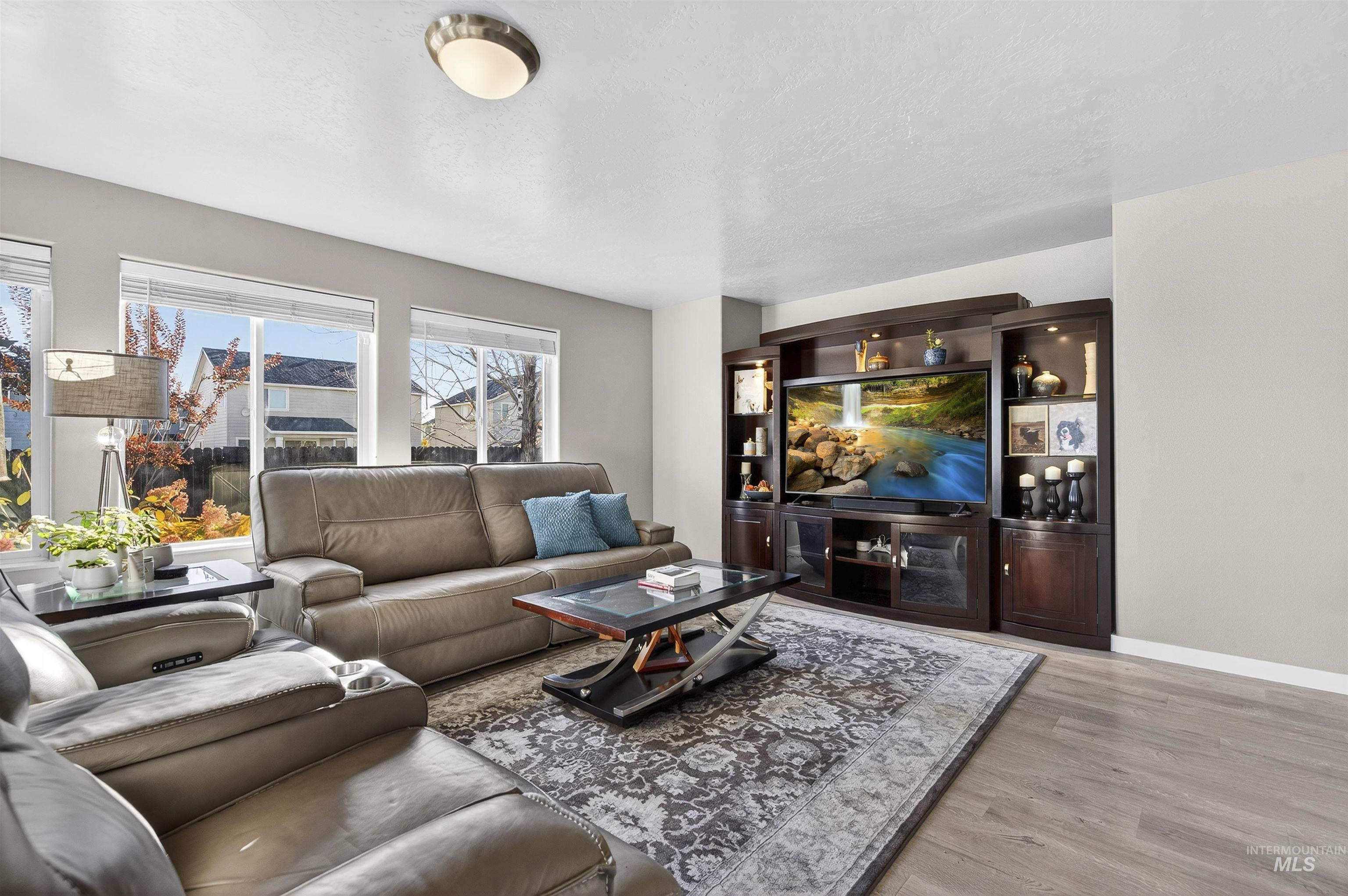 Living area featuring light wood-style flooring and baseboards