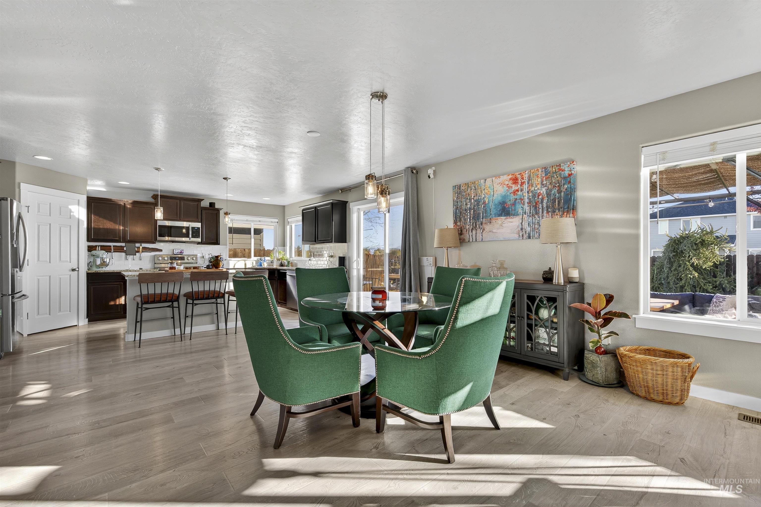 Dining room with light wood-style floors and baseboards