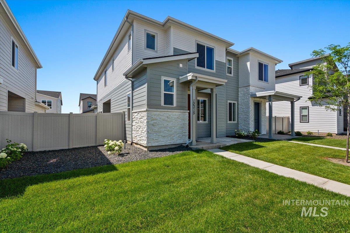 View of front facade featuring stone siding