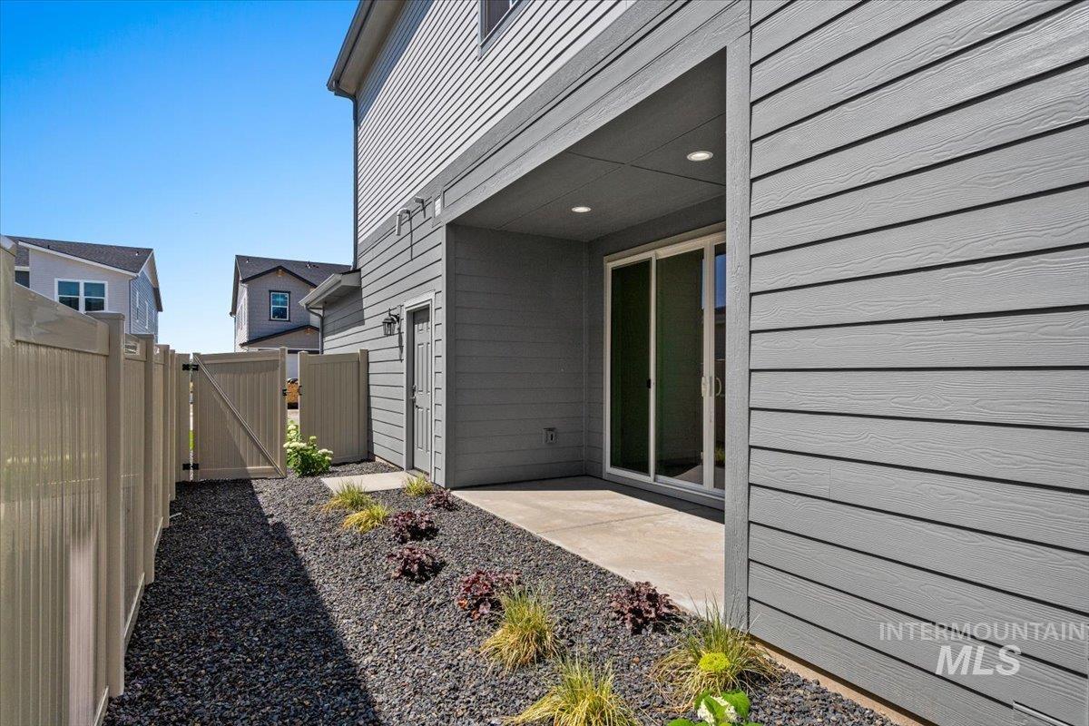View of yard featuring a gate and a patio area