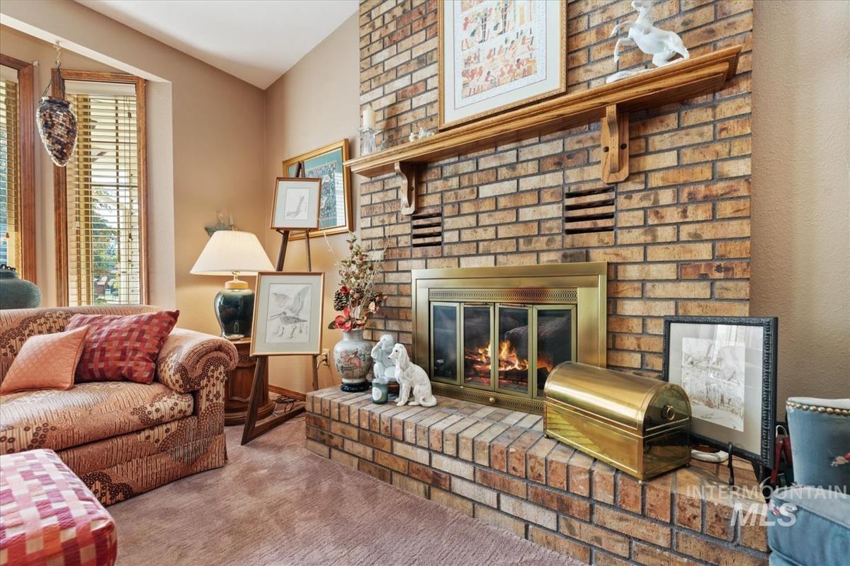 Living area featuring a fireplace and carpet flooring