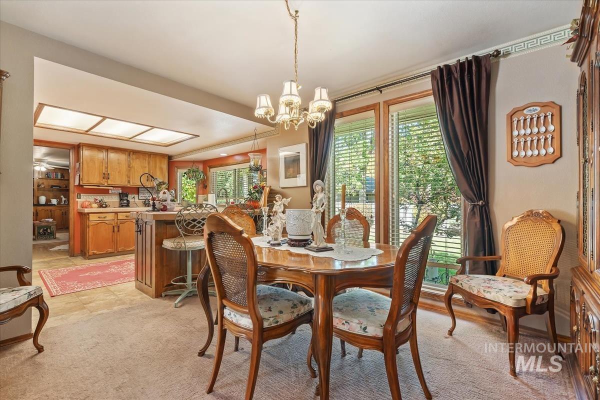 Dining room featuring a chandelier and light carpet