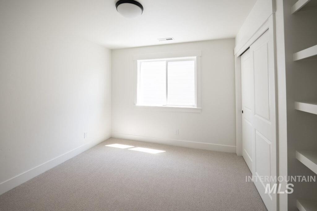 Unfurnished bedroom featuring carpet floors and a closet