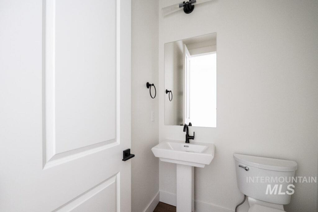Bathroom with toilet and baseboards