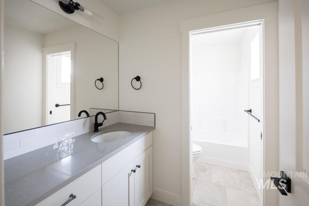 Bathroom featuring vanity and shower / tub combination