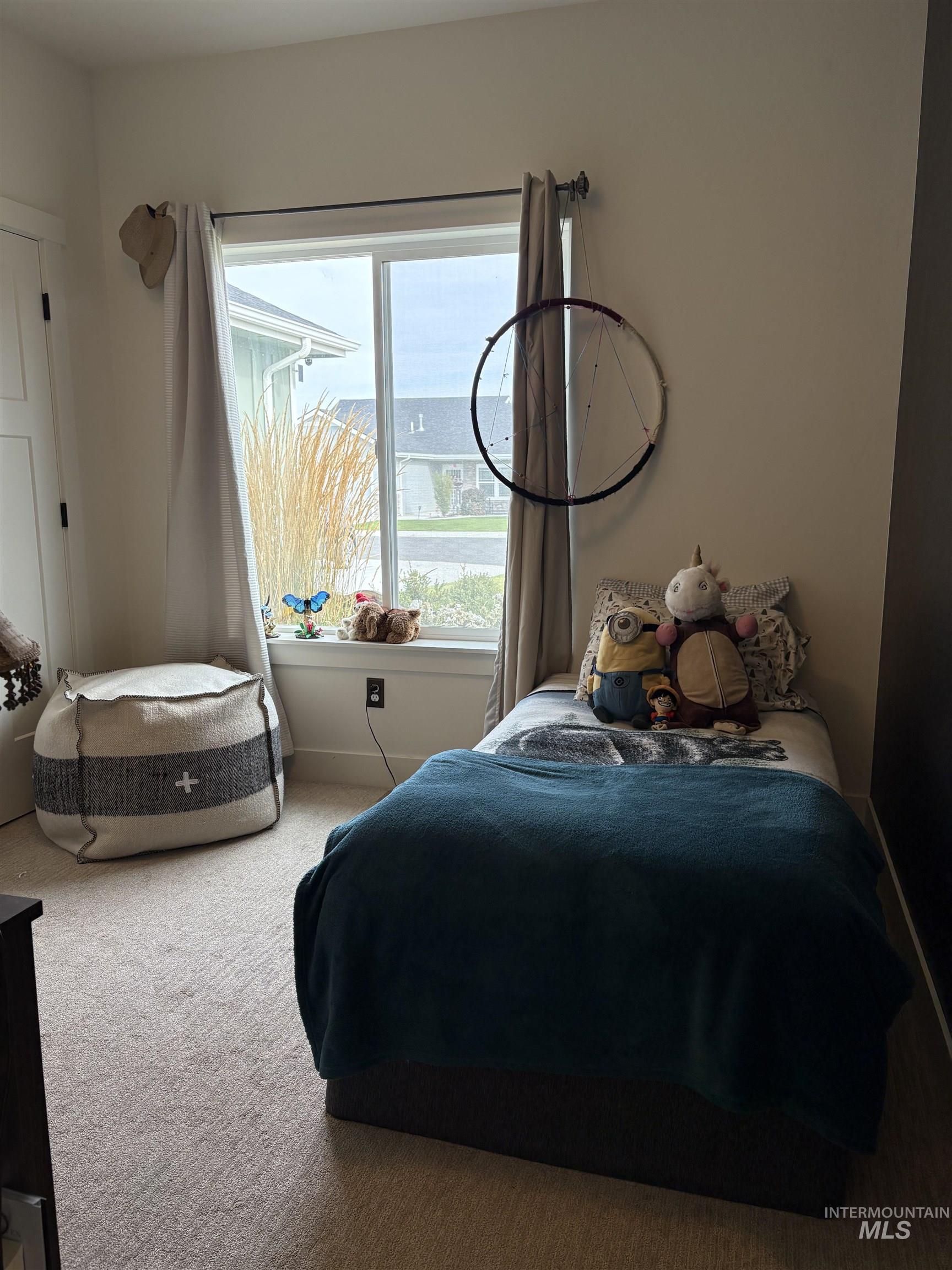 Carpeted bedroom with baseboards