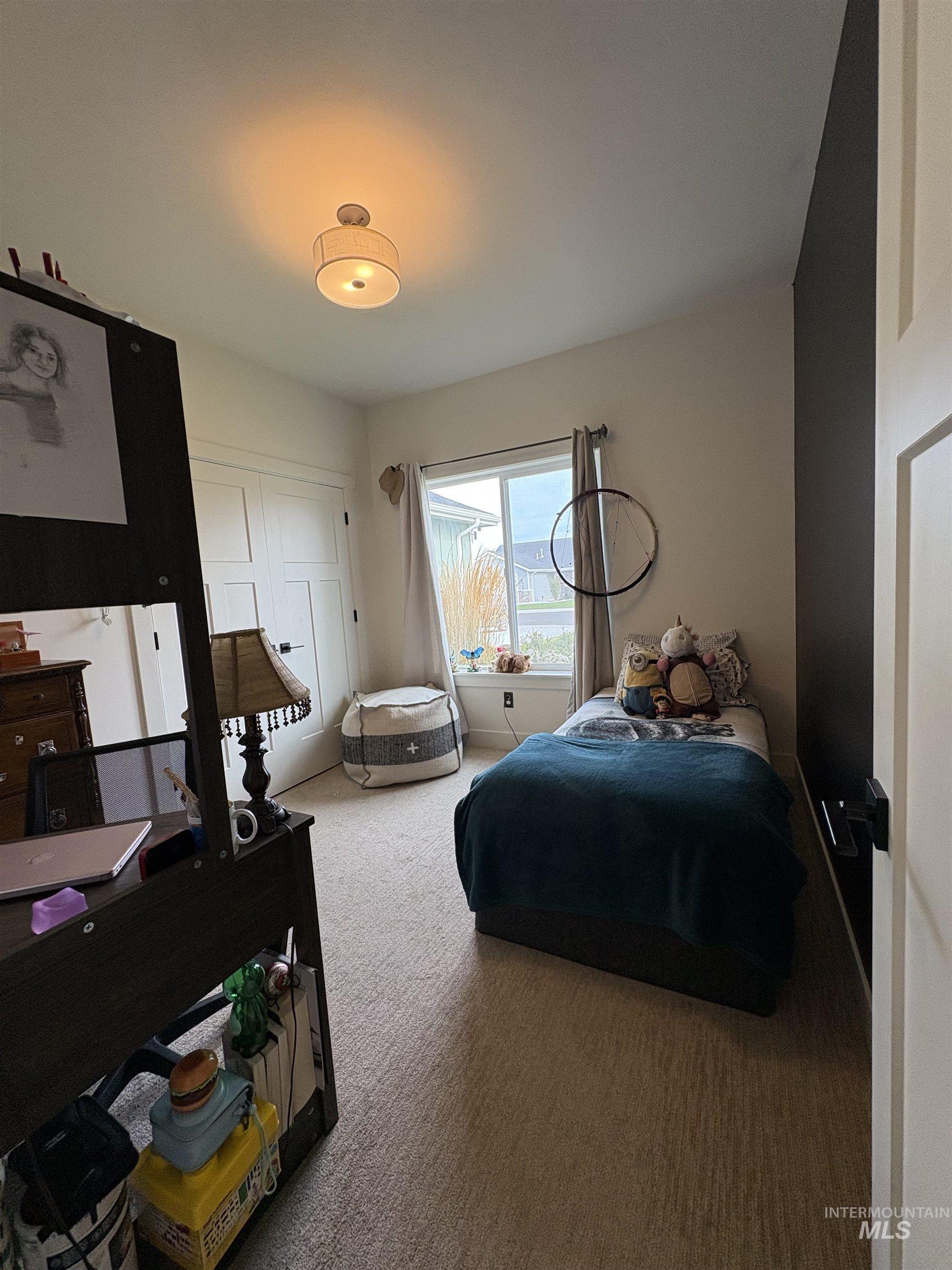 Bedroom with carpet and a closet