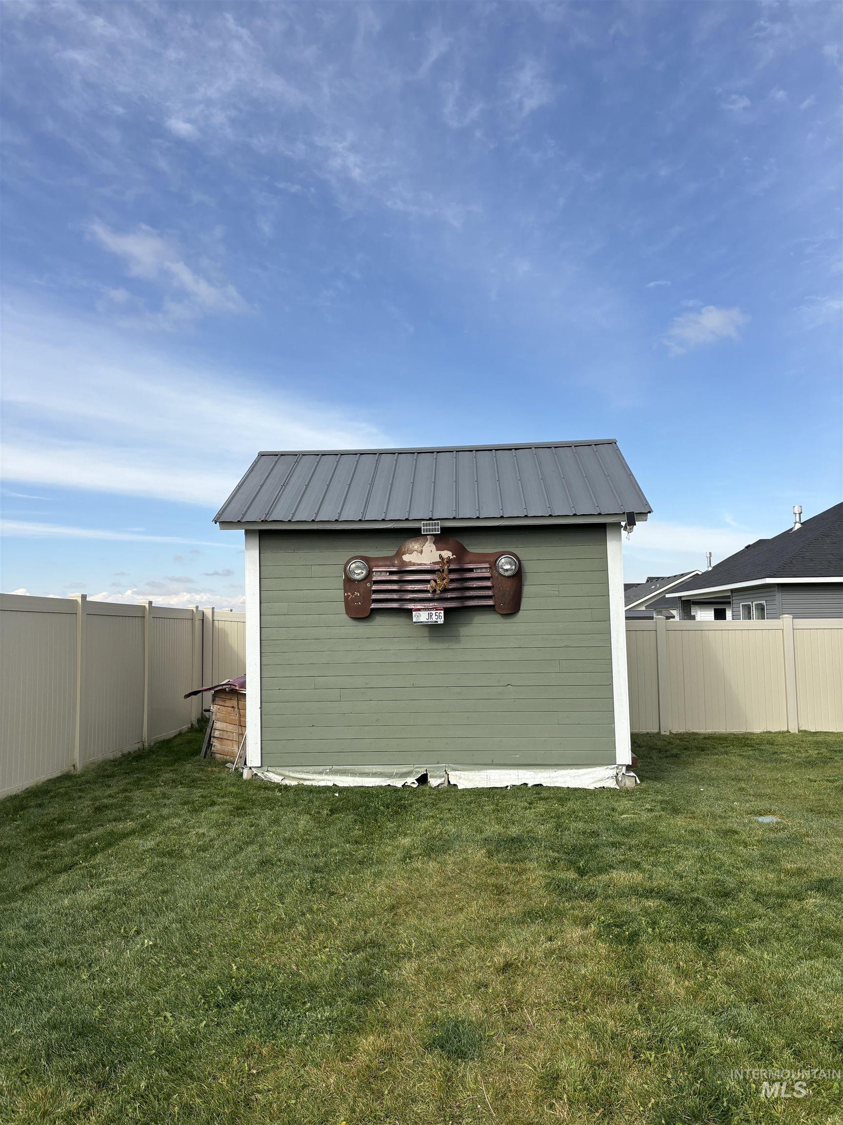 View of outdoor structure featuring a fenced backyard