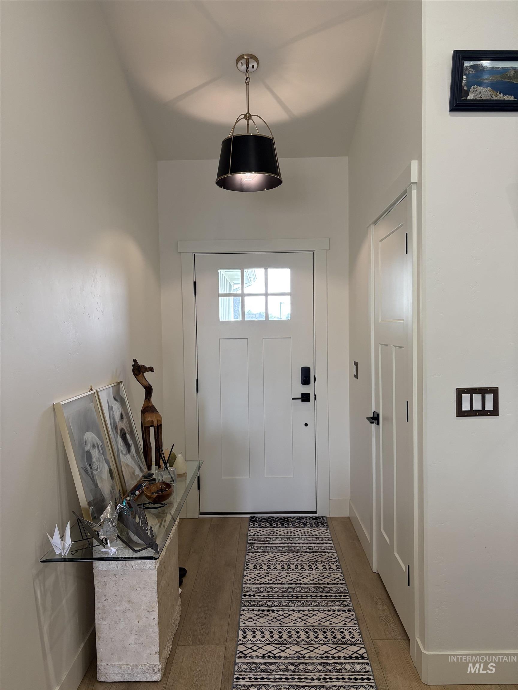 Entryway with wood finished floors and baseboards