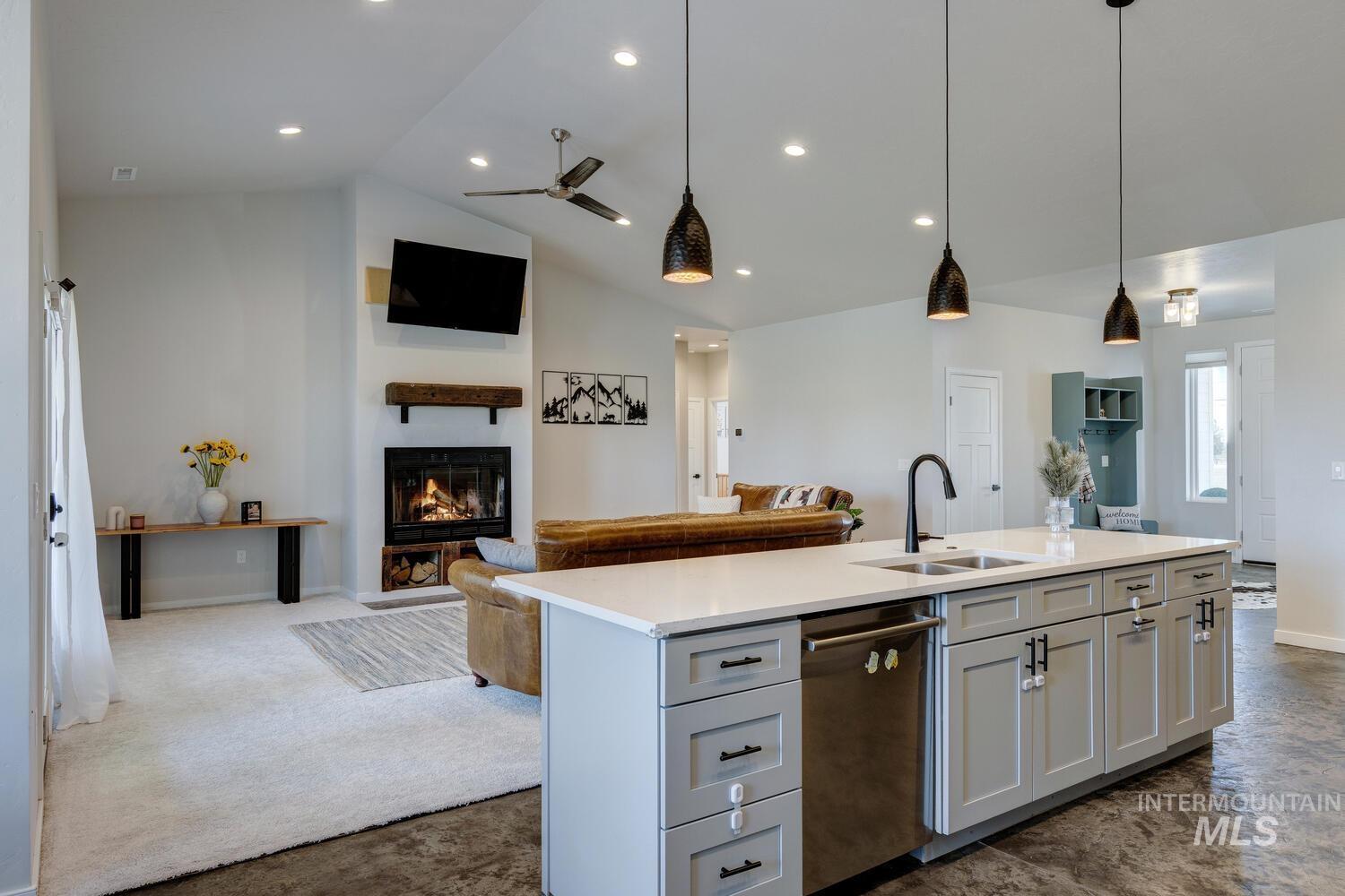Kitchen with open floor plan, pendant lighting, dishwasher, ceiling fan, and recessed lighting