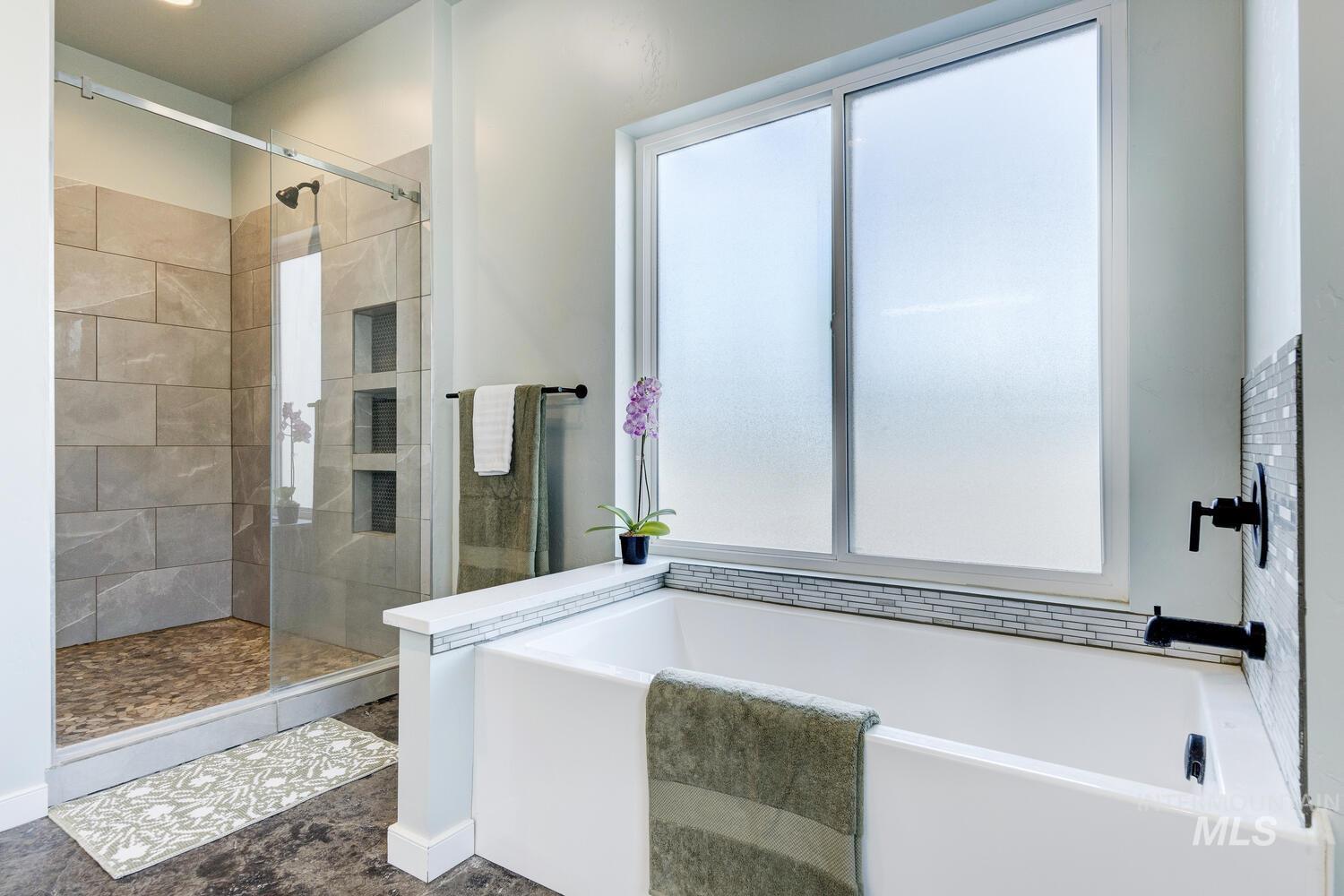 Bathroom featuring a garden tub and a stall shower