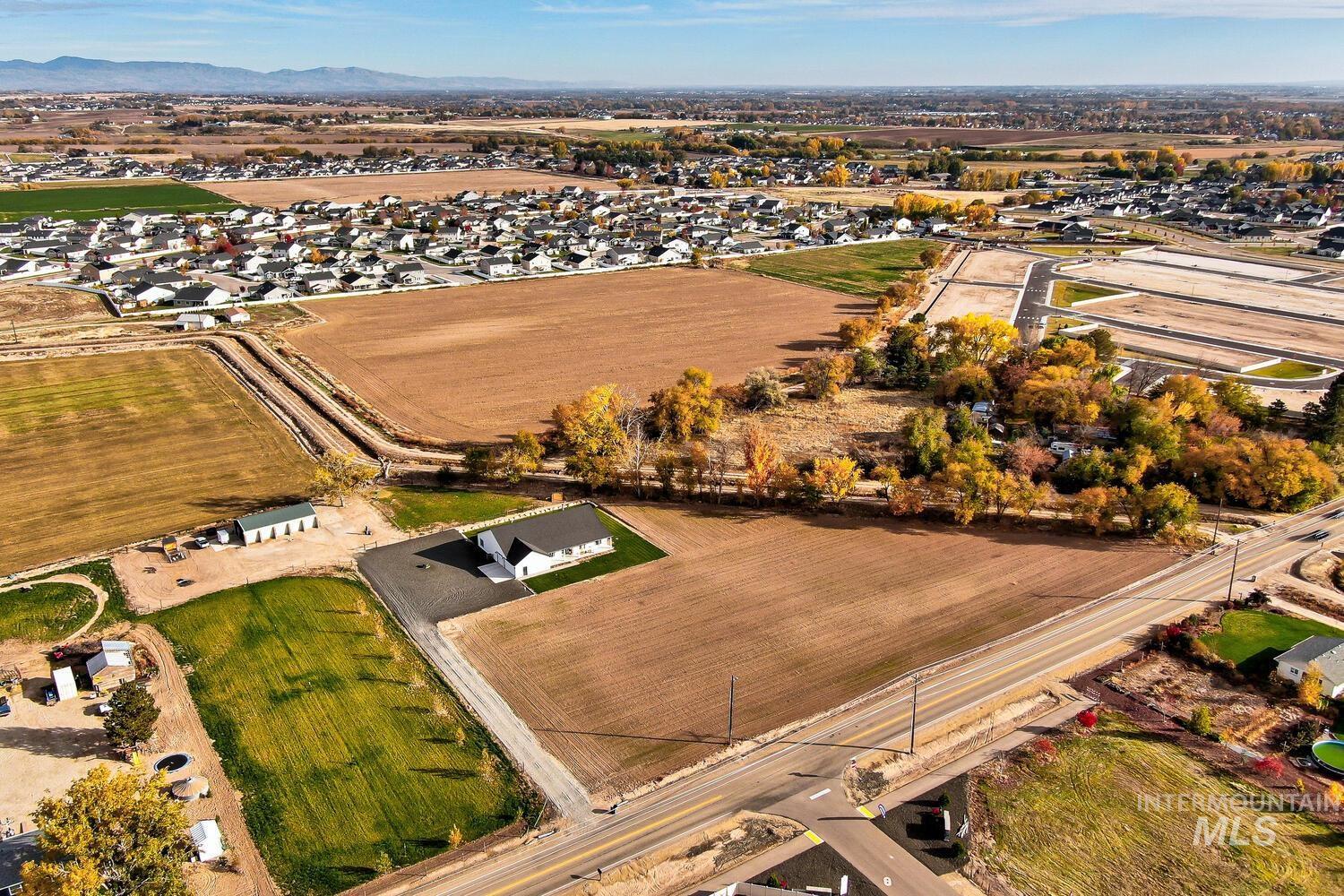 Aerial view of property's location featuring rural landscape and mountains