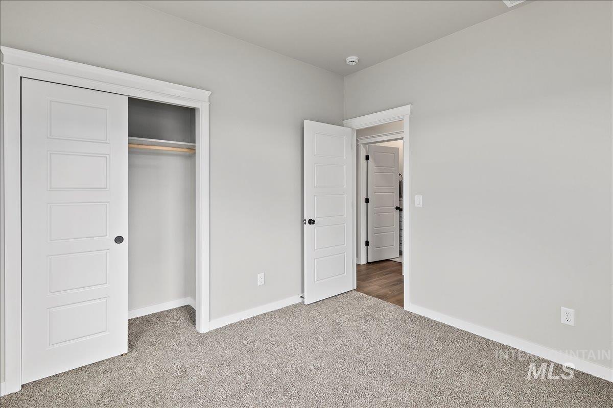 Unfurnished bedroom featuring carpet floors and a closet